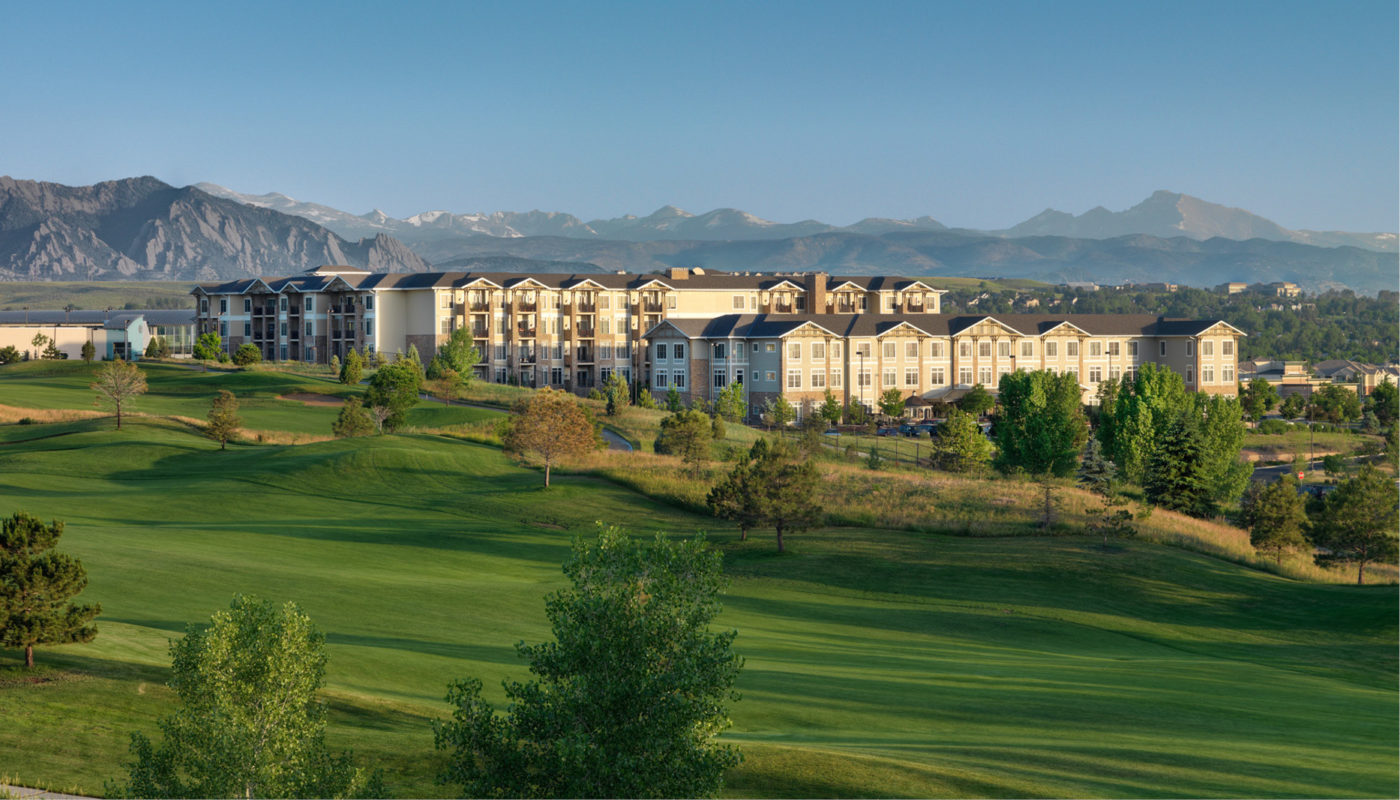 A picturesque golf course with the majestic mountains of FlatIrons providing a stunning backdrop, especially during sunrise.