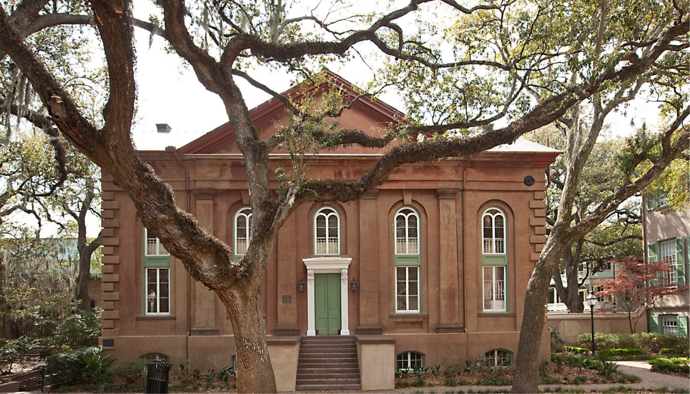 Randolph Hall, a brown brick building with a green door, is located at the College of Charleston.