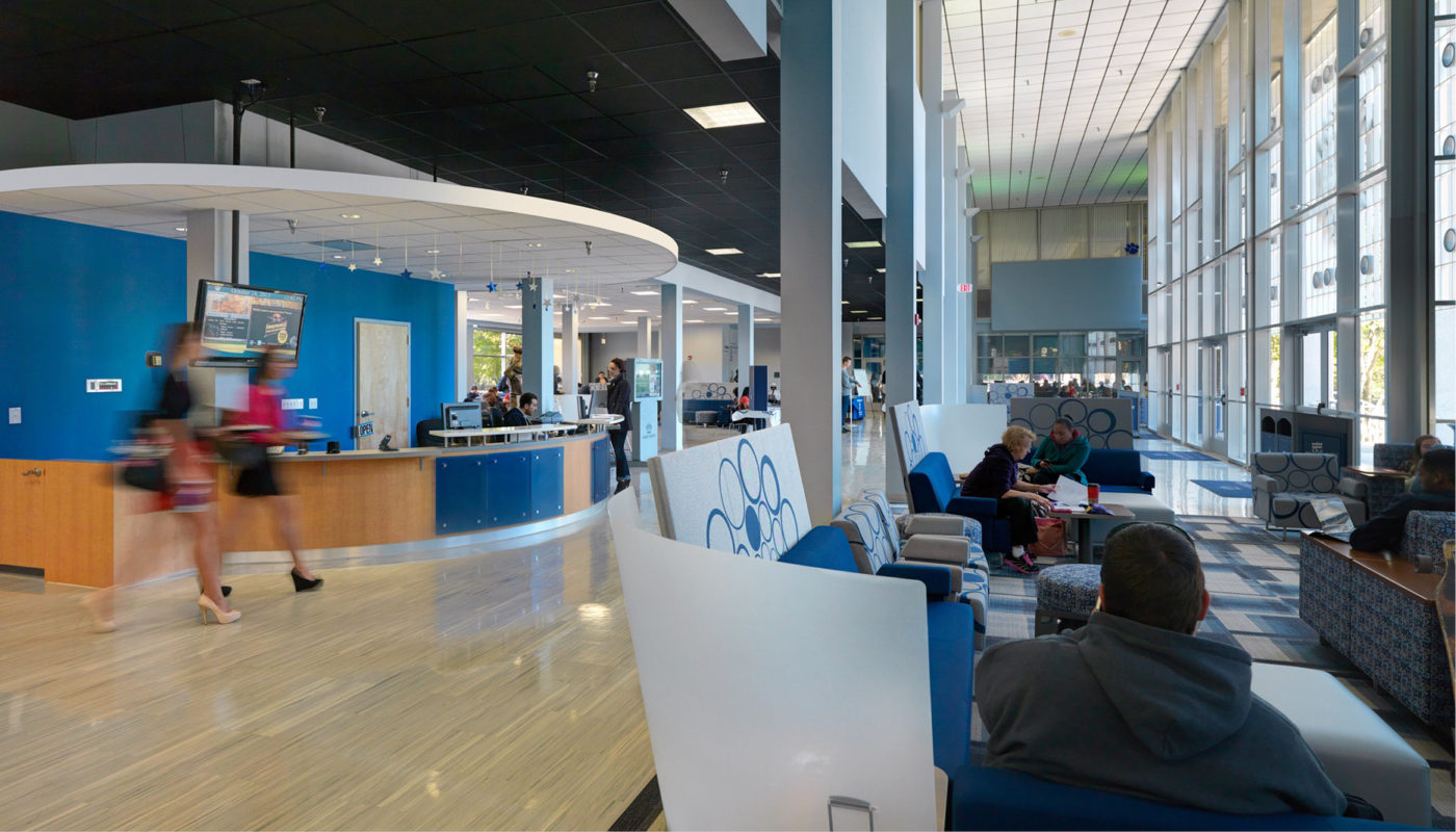 The lobby of Webb Center at Old Dominion University, with people sitting in chairs.