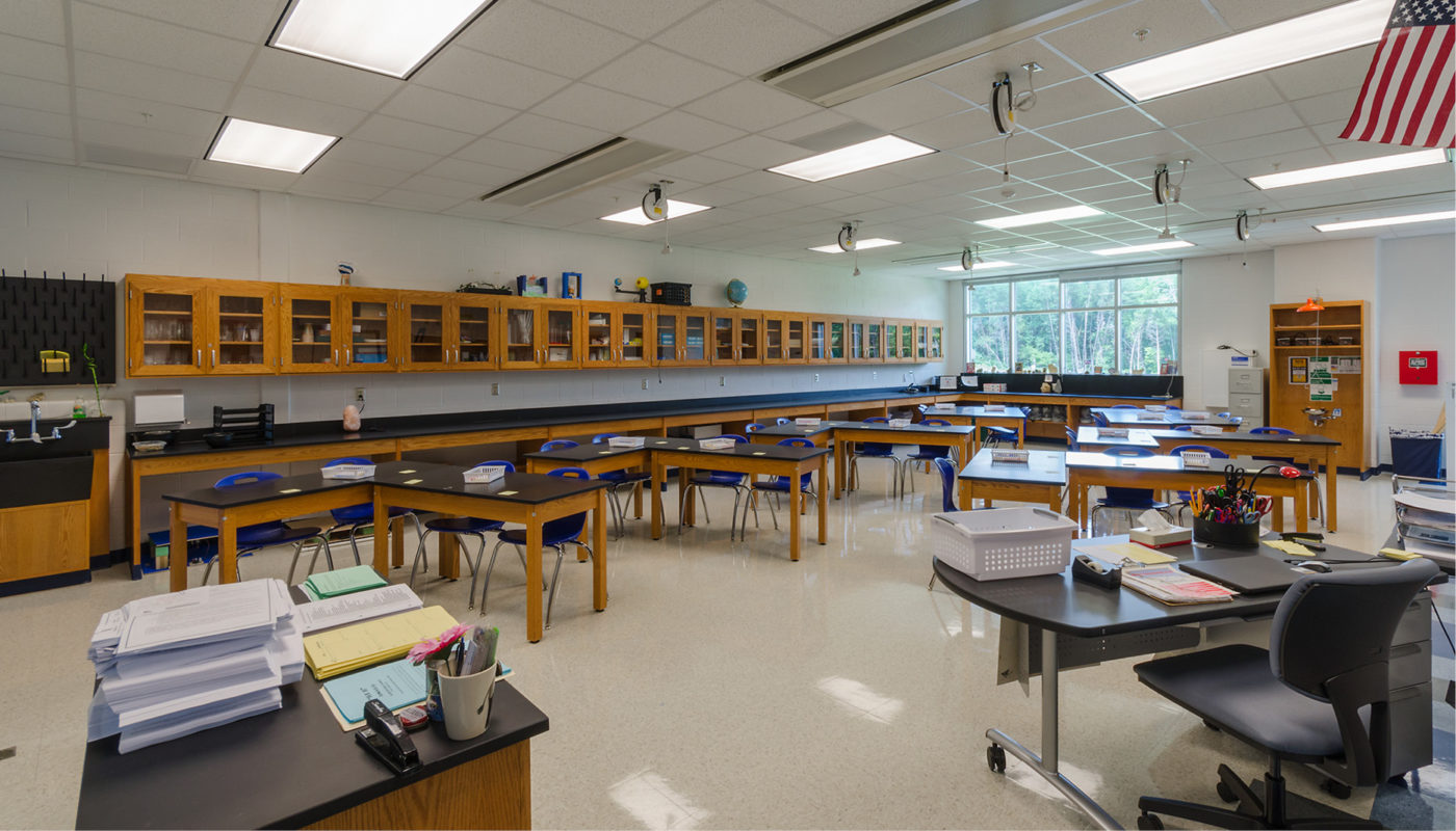 A classroom filled with desks and tables at Colgan High School, part of Prince William County Public Schools.