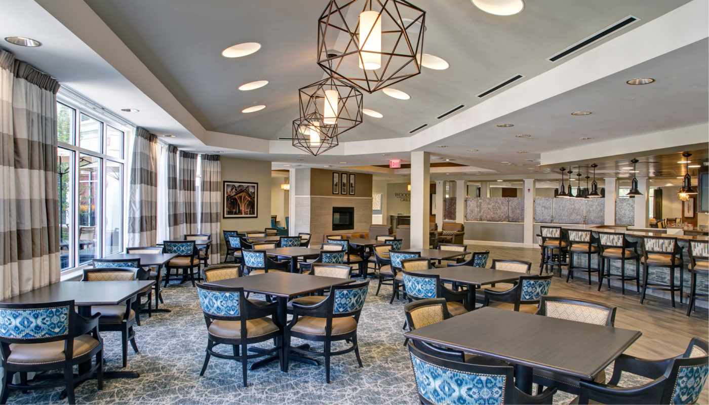 Maris Grove boasts a spacious dining room adorned with tables and chairs, providing a welcoming atmosphere for residents and visitors alike.