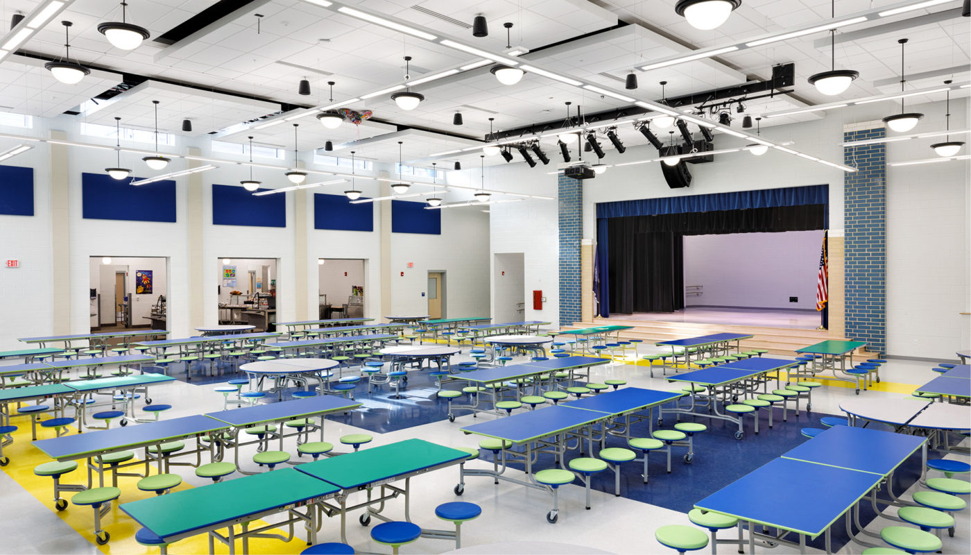 The Patrick Henry K-8 School cafeteria provides a comfortable and inviting space with tables and chairs for students of Alexandria City Public Schools to enjoy their meals.