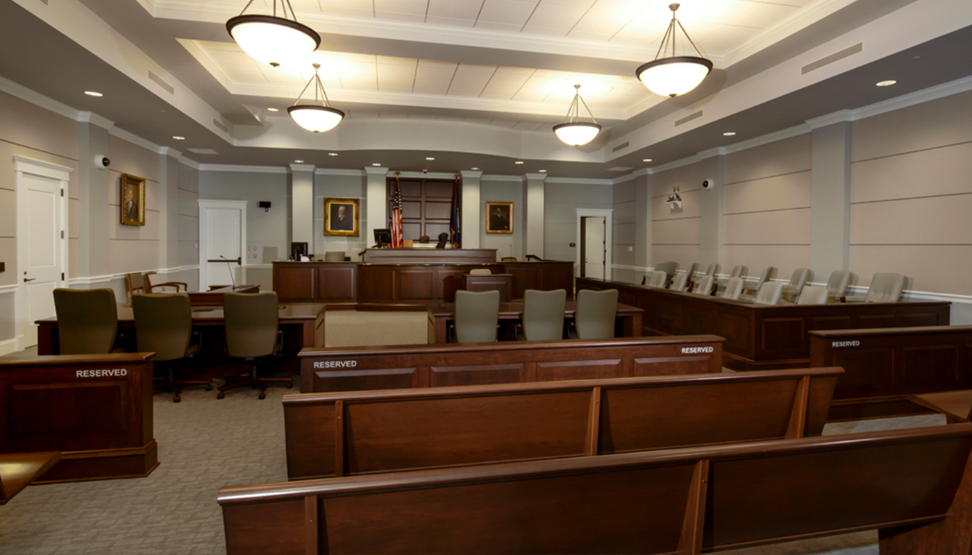 A courtroom with benches and chairs.