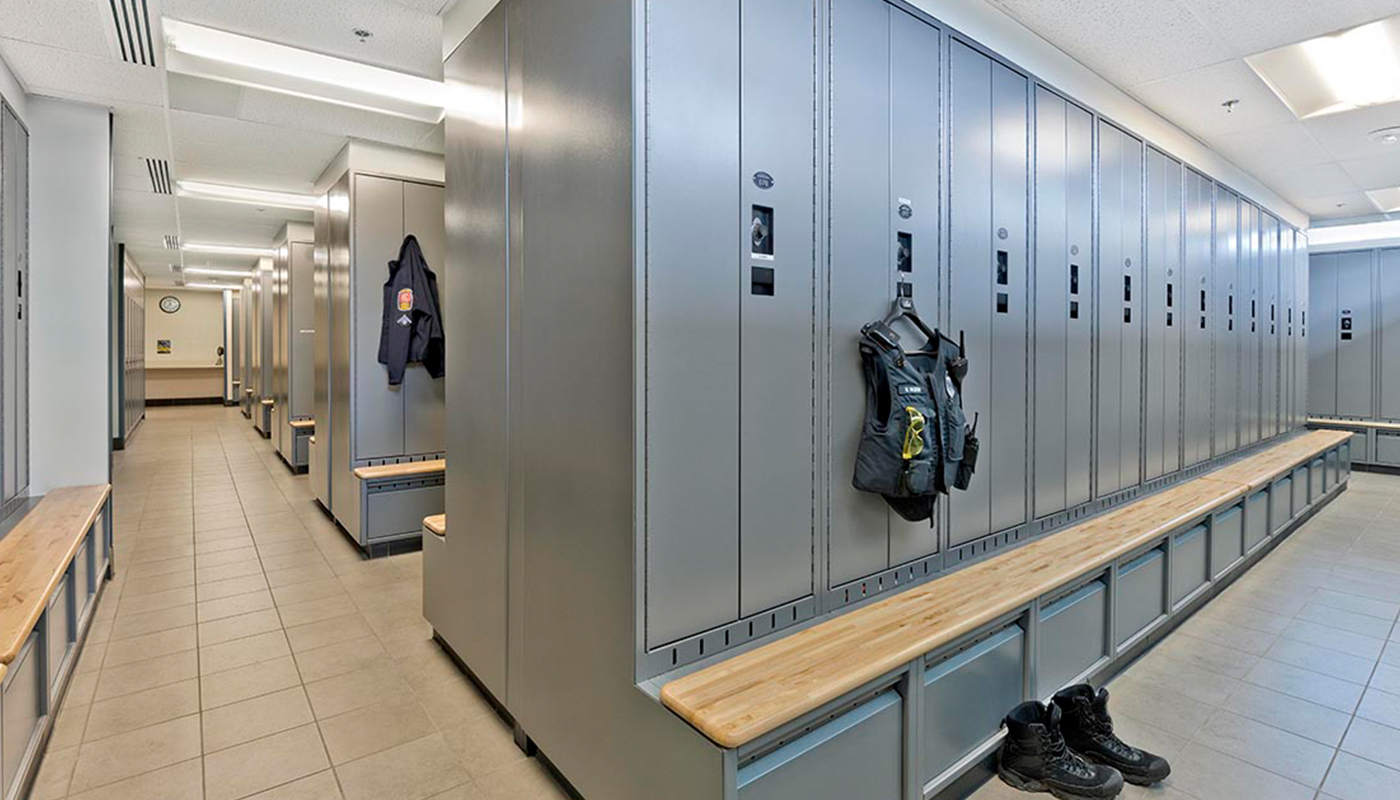 A locker room with many lockers and benches.