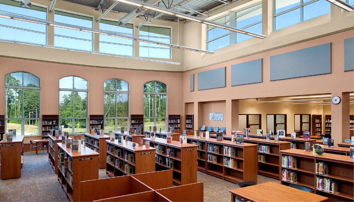 A library located in Carrboro High School with a large number of bookshelves.