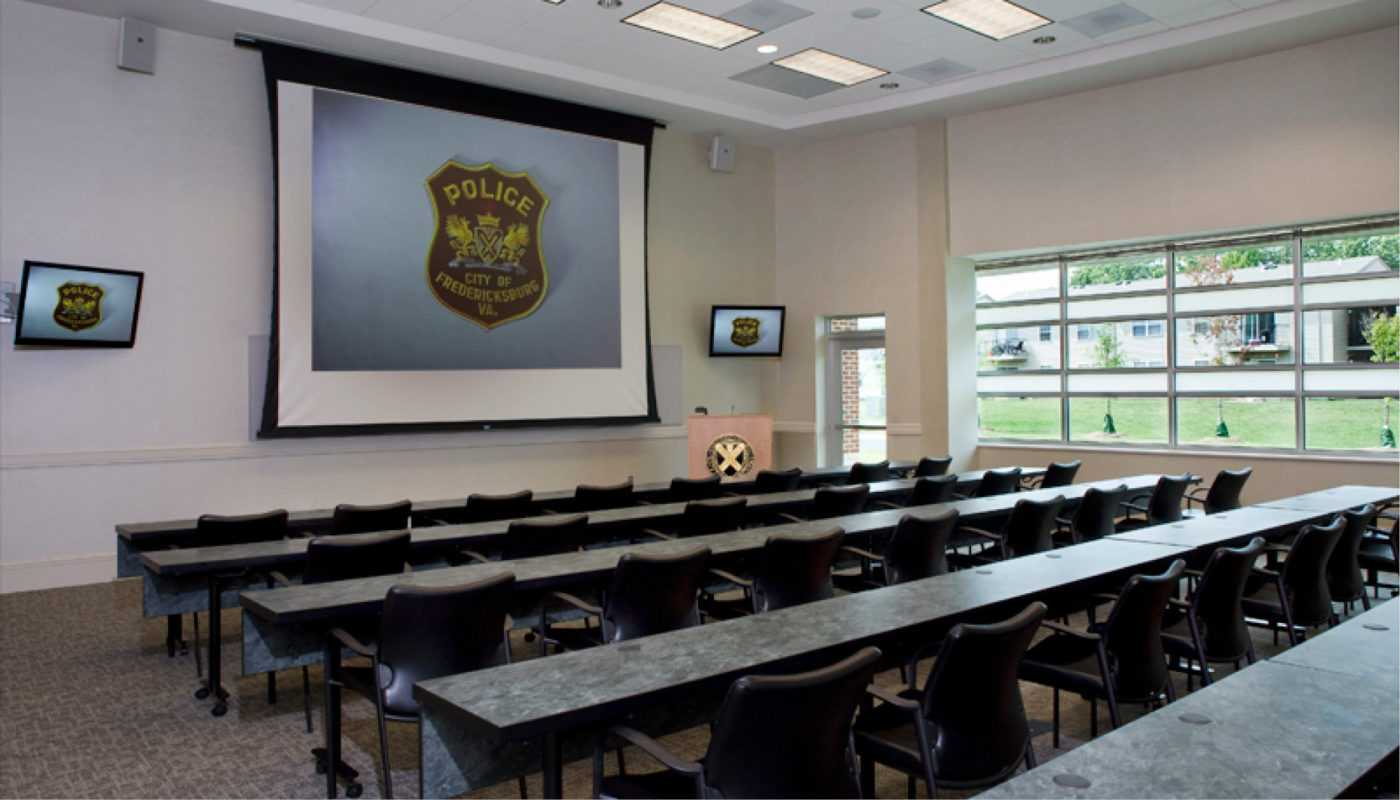 A conference room with a projector screen.