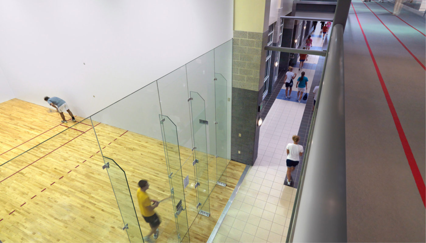 A view of a squash court at Longwood University's wellness center with people playing on it, promoting health and wellness.