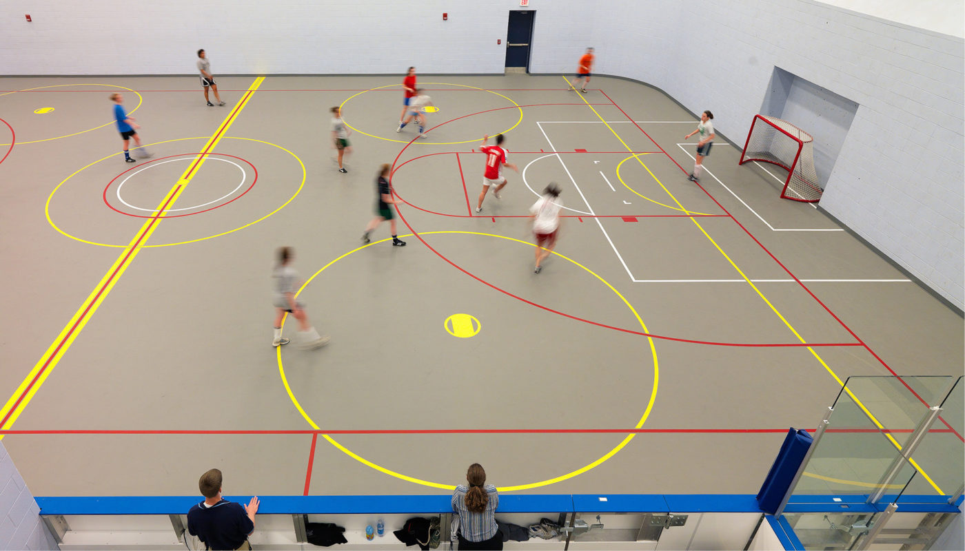 A recreation group playing soccer in an indoor court at Old Dominion University's Wellness Center.