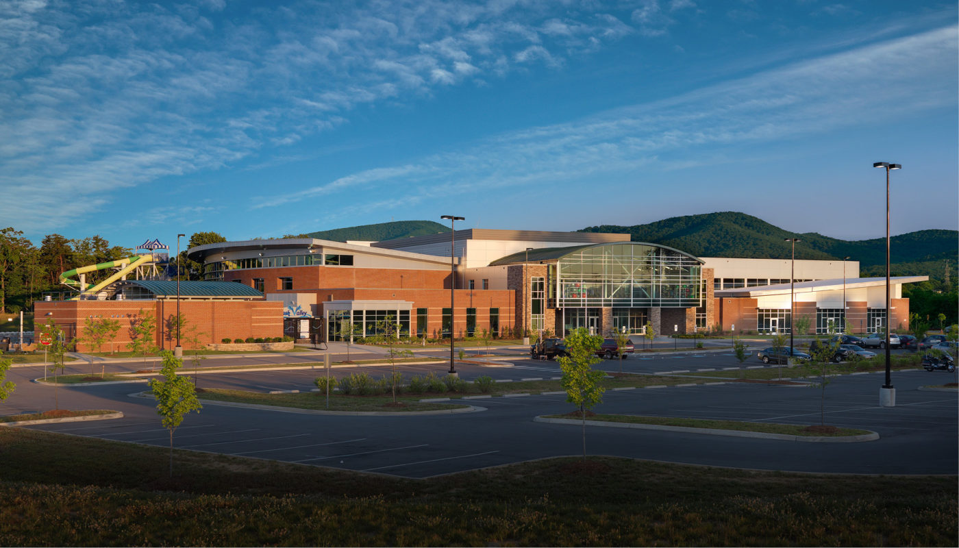 The Green Ridge Recreation Center, located in Roanoke County, is a large building situated in the middle of a parking lot.