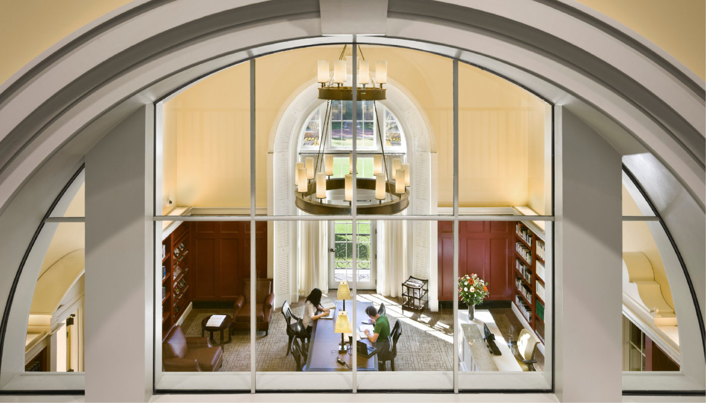 An arched window in a room with a table and chairs.