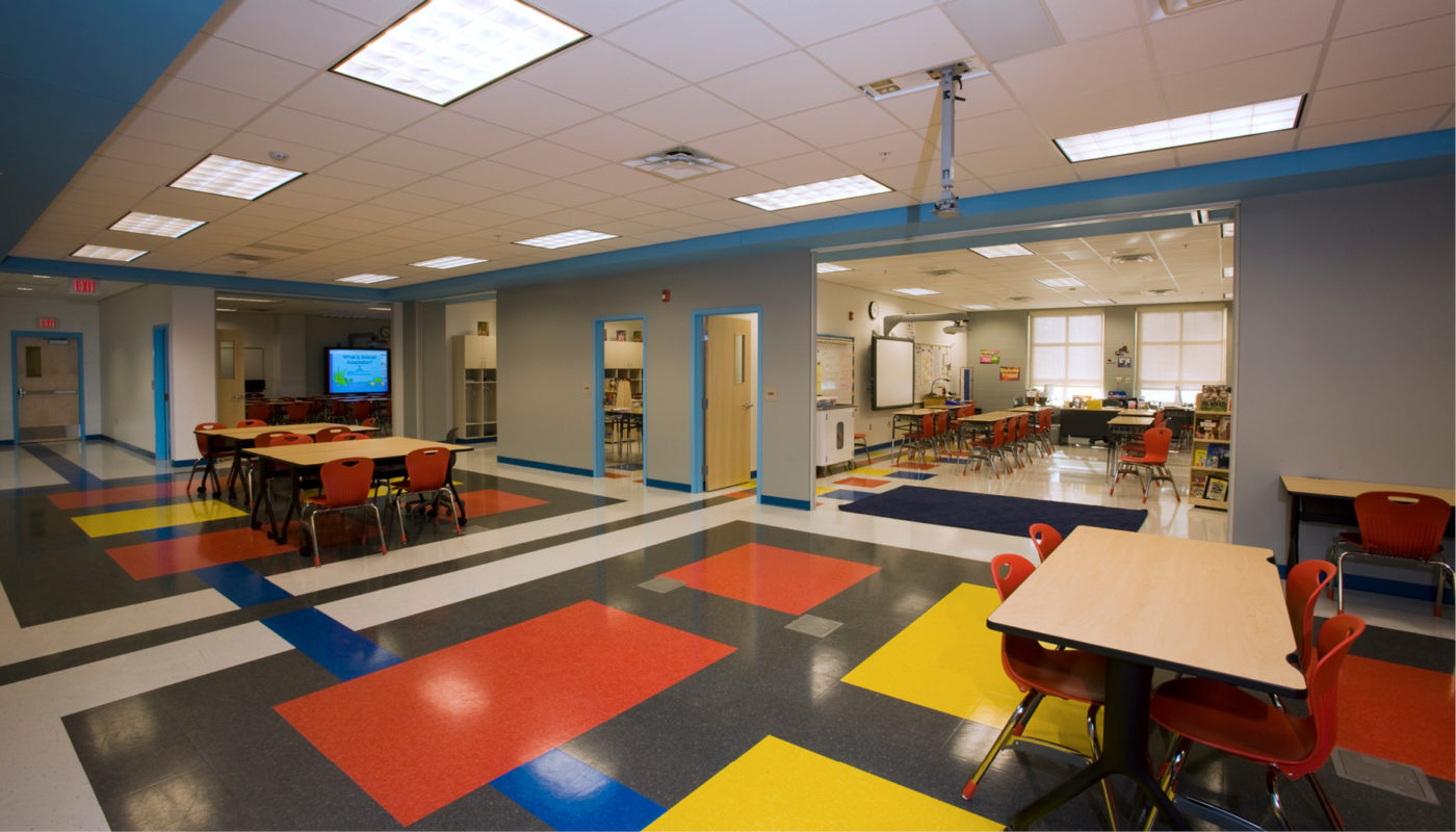 A colorful classroom at Andrews PreK-8 School with tables and chairs.