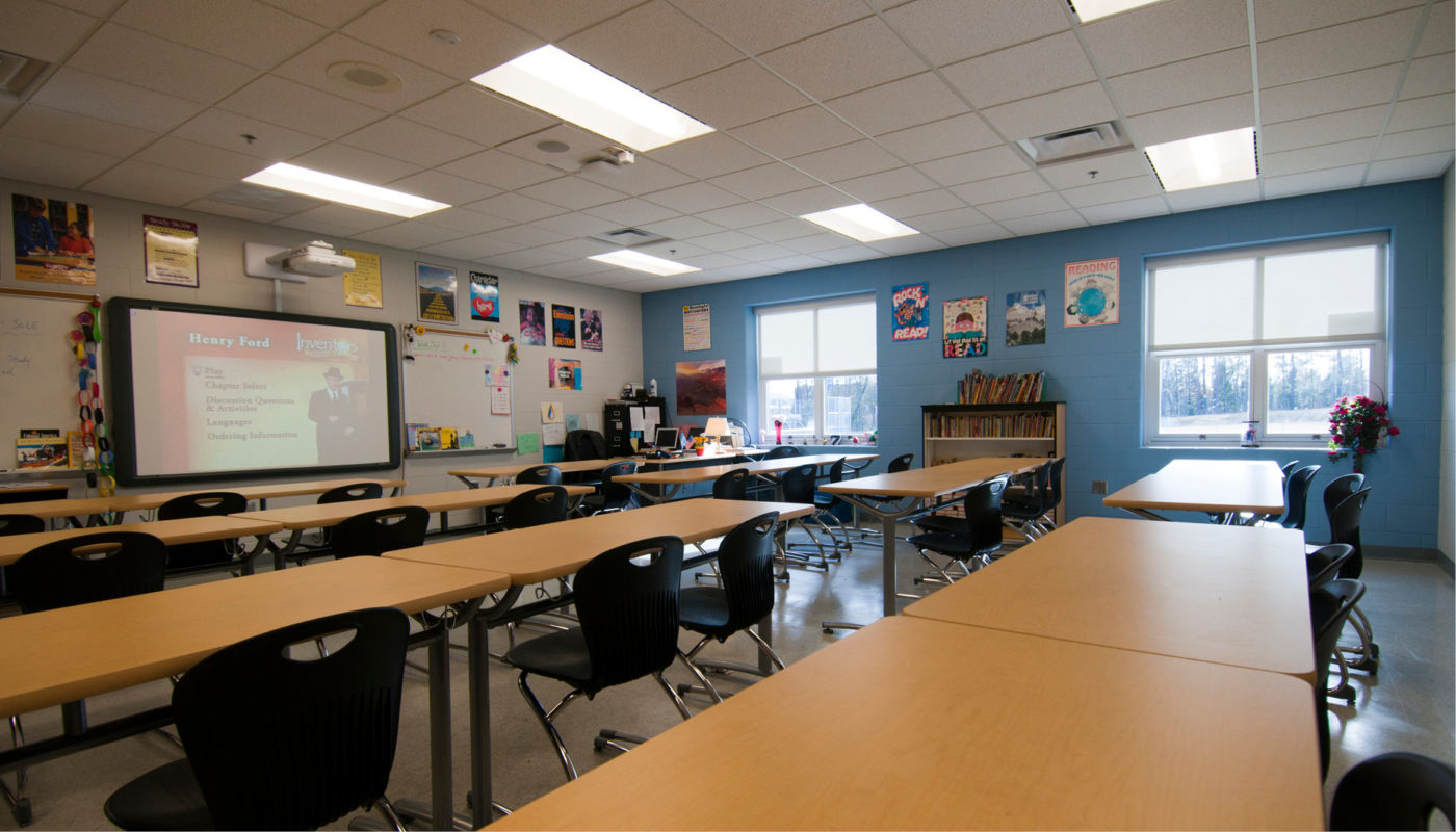 A classroom at Holman Middle School with tables and chairs.