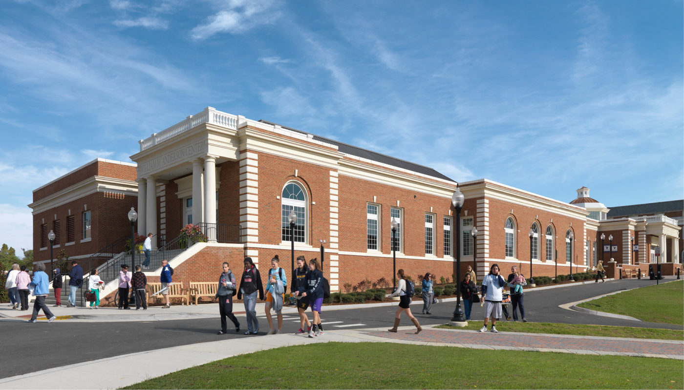 A rendering of a brick building with people walking in front of it.