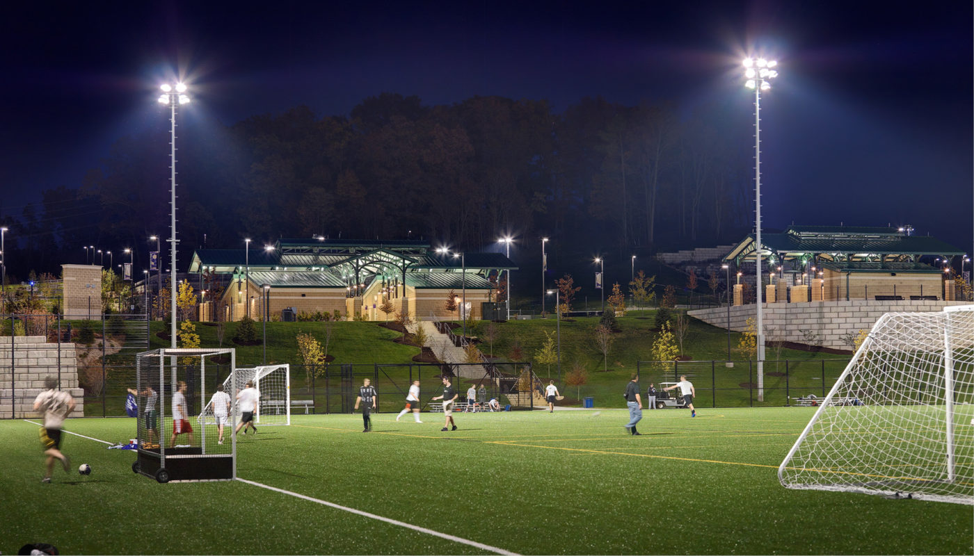 A soccer field lit up at night.