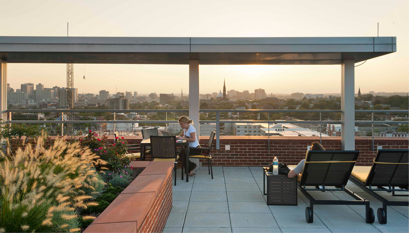 A rooftop patio with a view of the city.