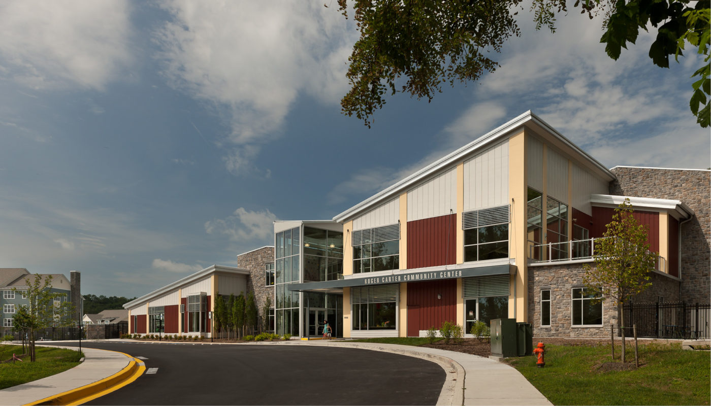 The Roger Carter Community Center, located in Maryland, Baltimore, features a school building with a large parking lot.