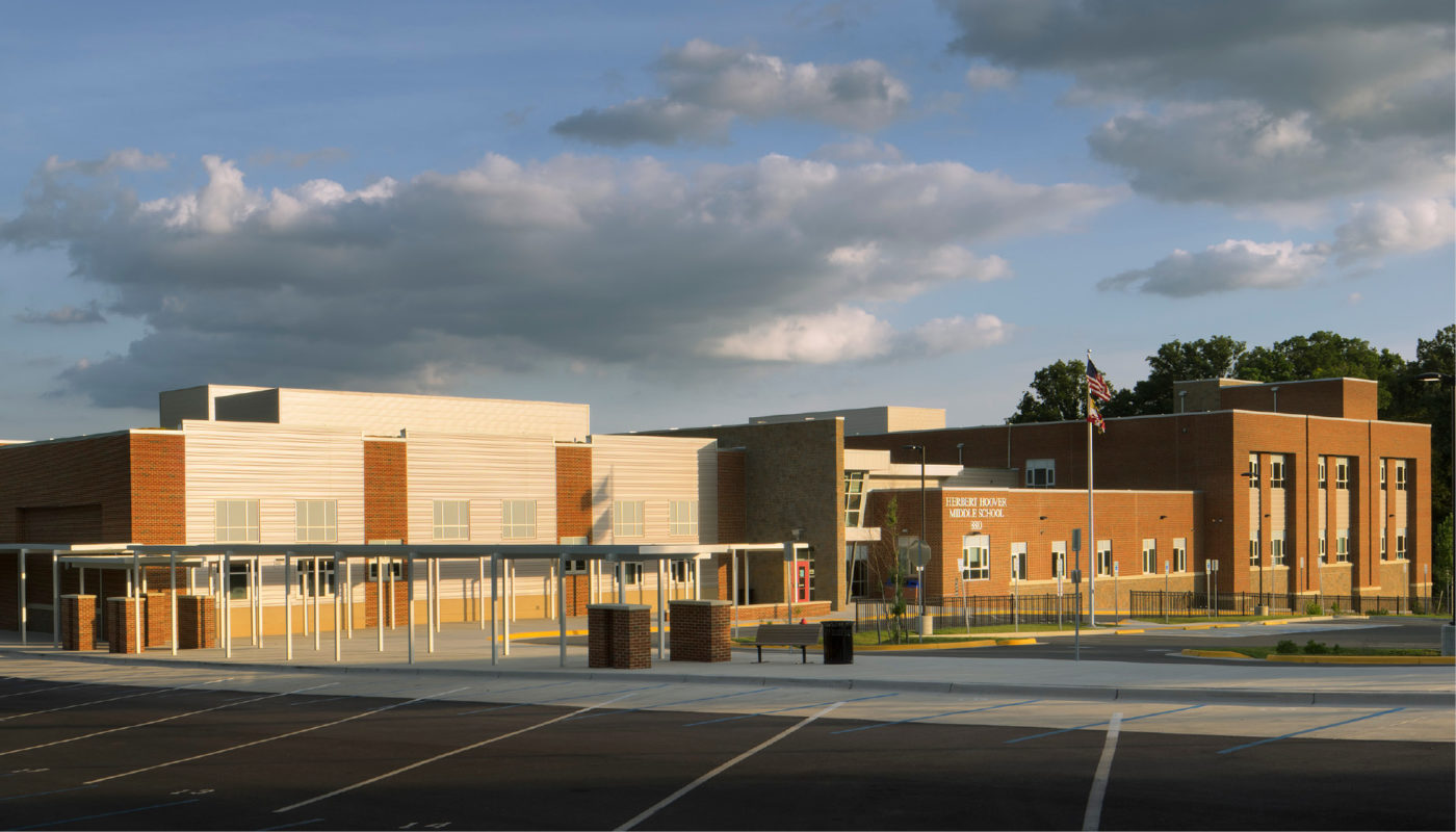 A rendering of Herbert Hoover Middle School, a Montgomery County Public Schools building, with a parking lot.