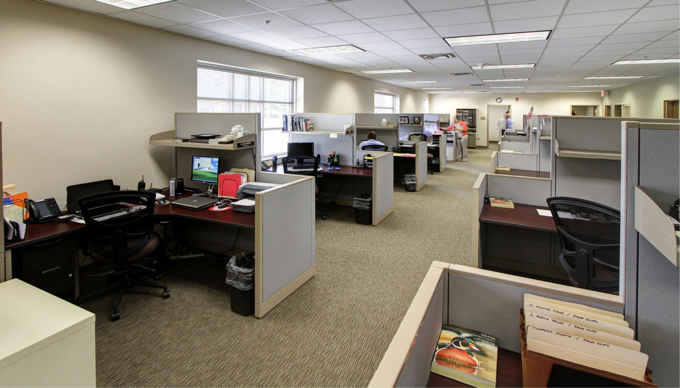 An office with many cubicles and desks.