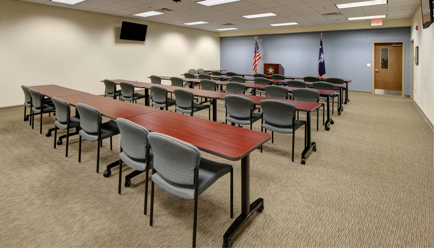 A conference room with tables and chairs.
