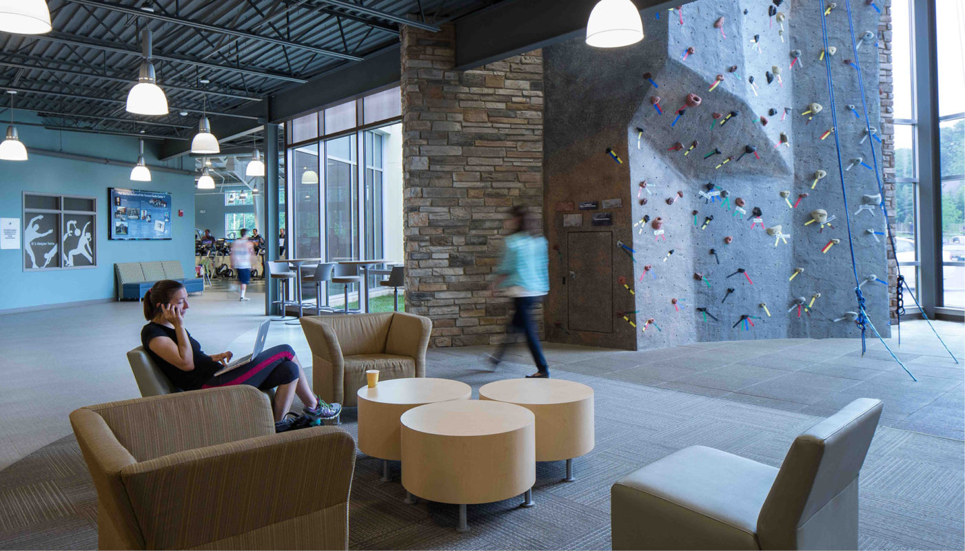 The Orokawa Family Center in Maryland offers a modern lobby equipped with a climbing wall for fun and chairs for relaxation.