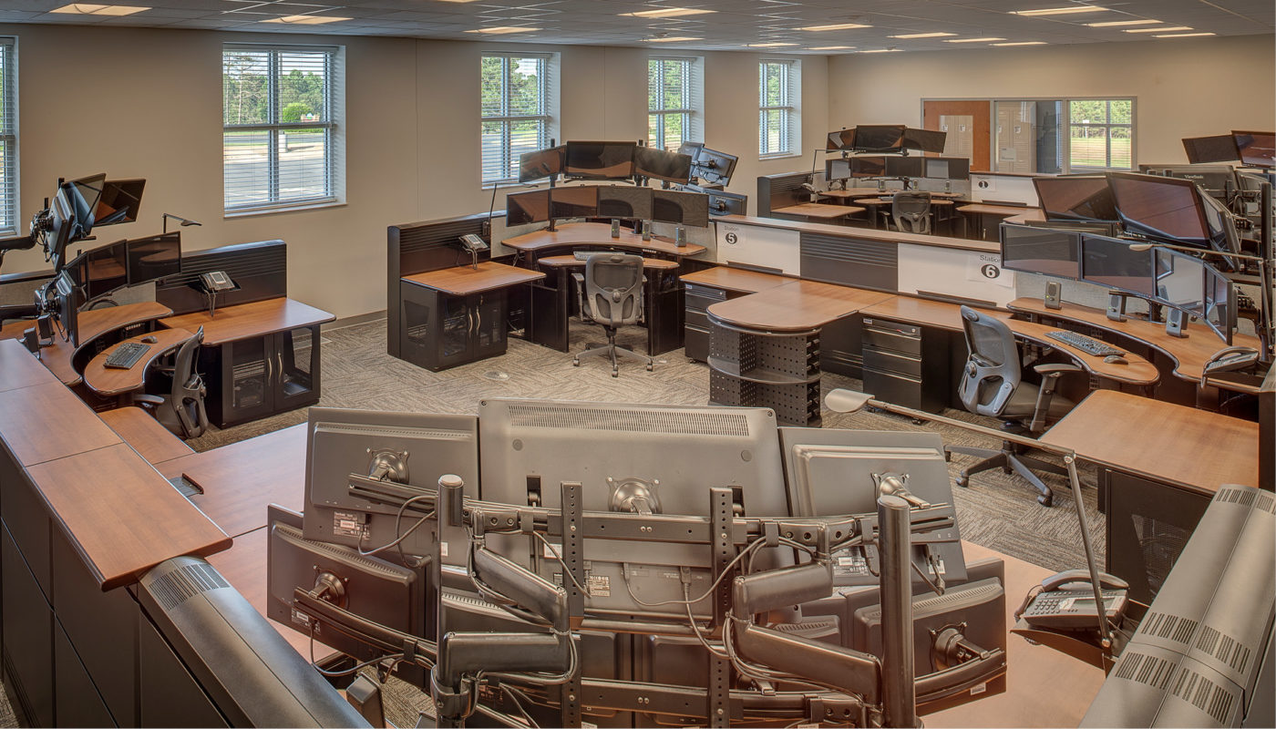 An emergency services command center with multiple desks and monitors for efficient coordination and response.