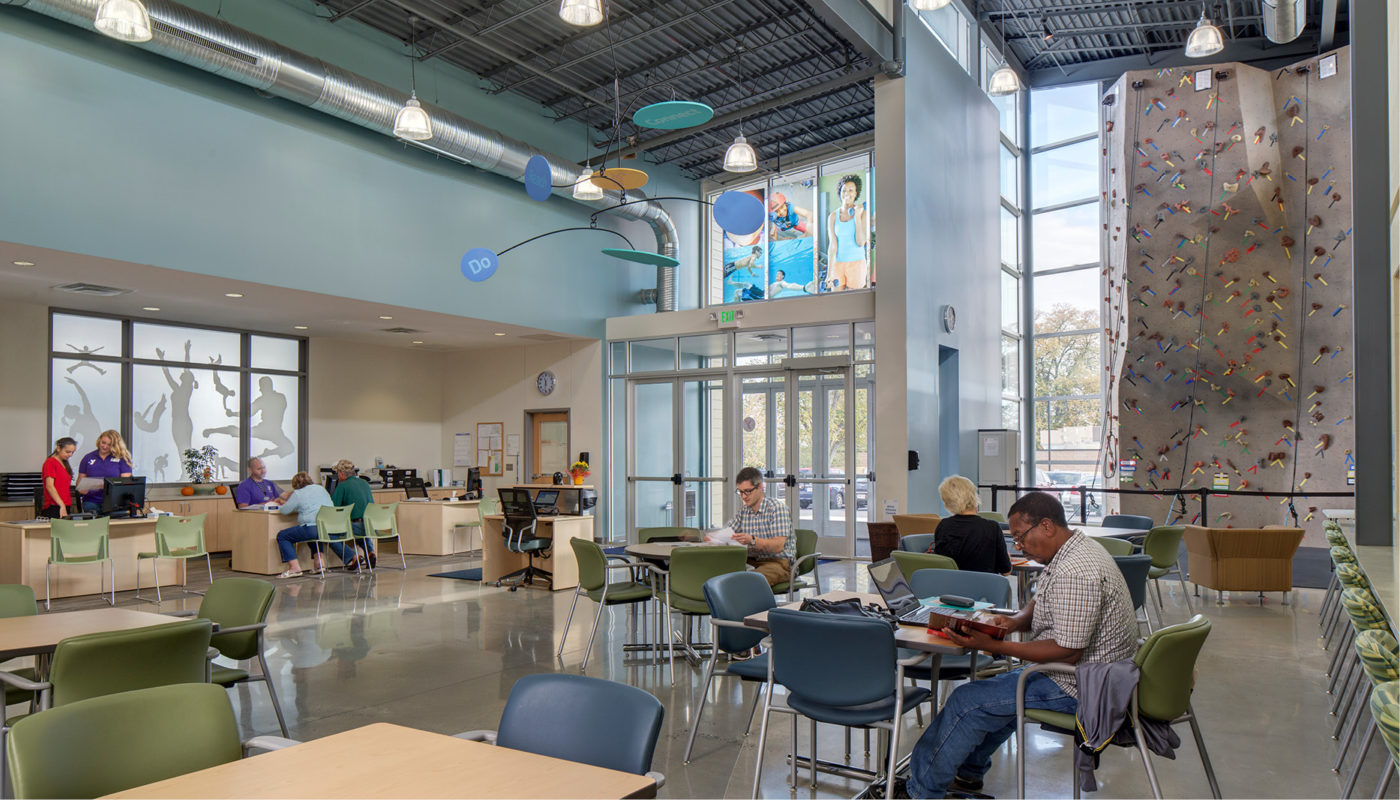 A Maryland cafeteria in Catonsville, featuring tables and chairs for dining and a climbing wall for added family fun.