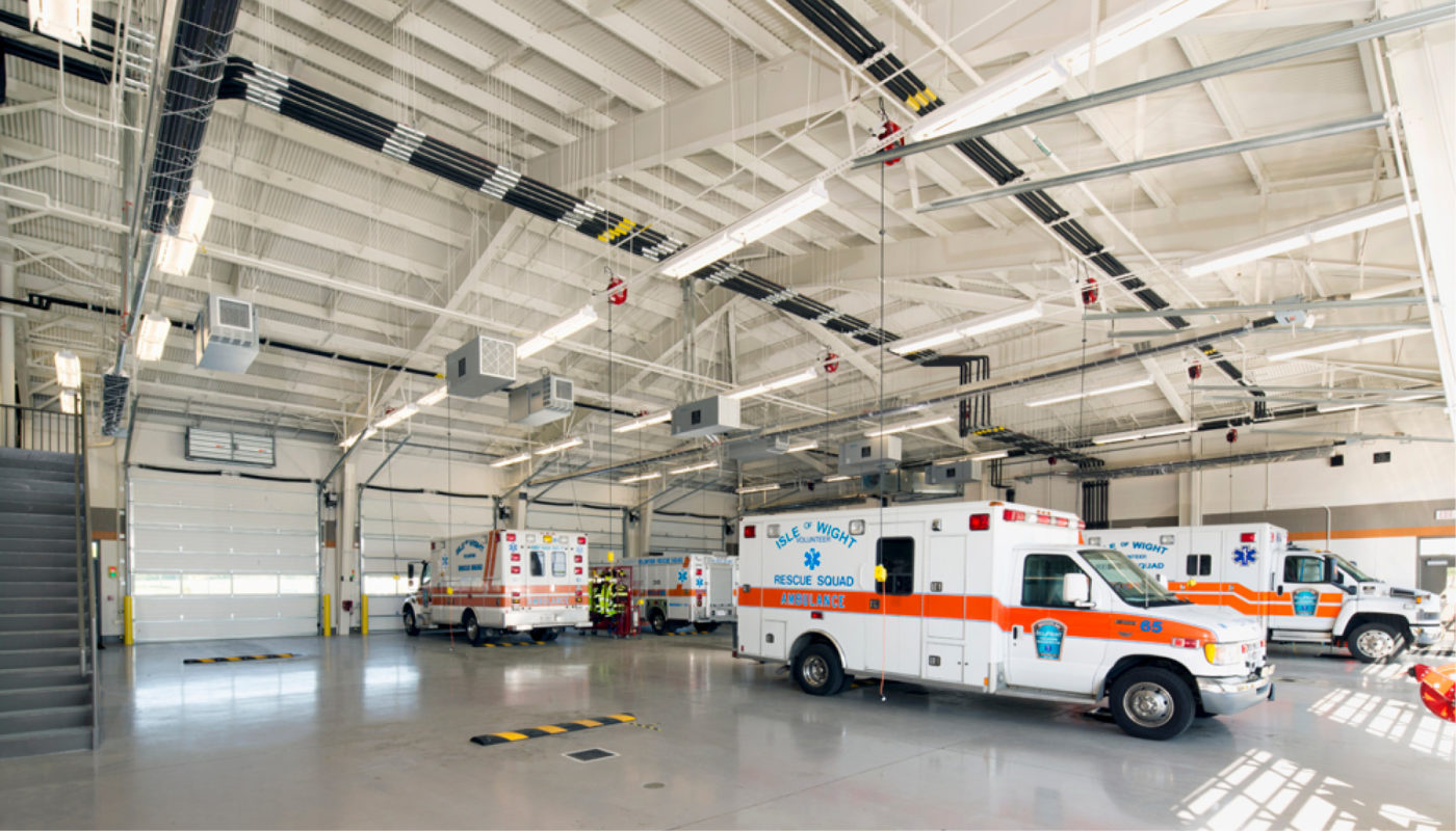 Two ambulances parked in a garage.
