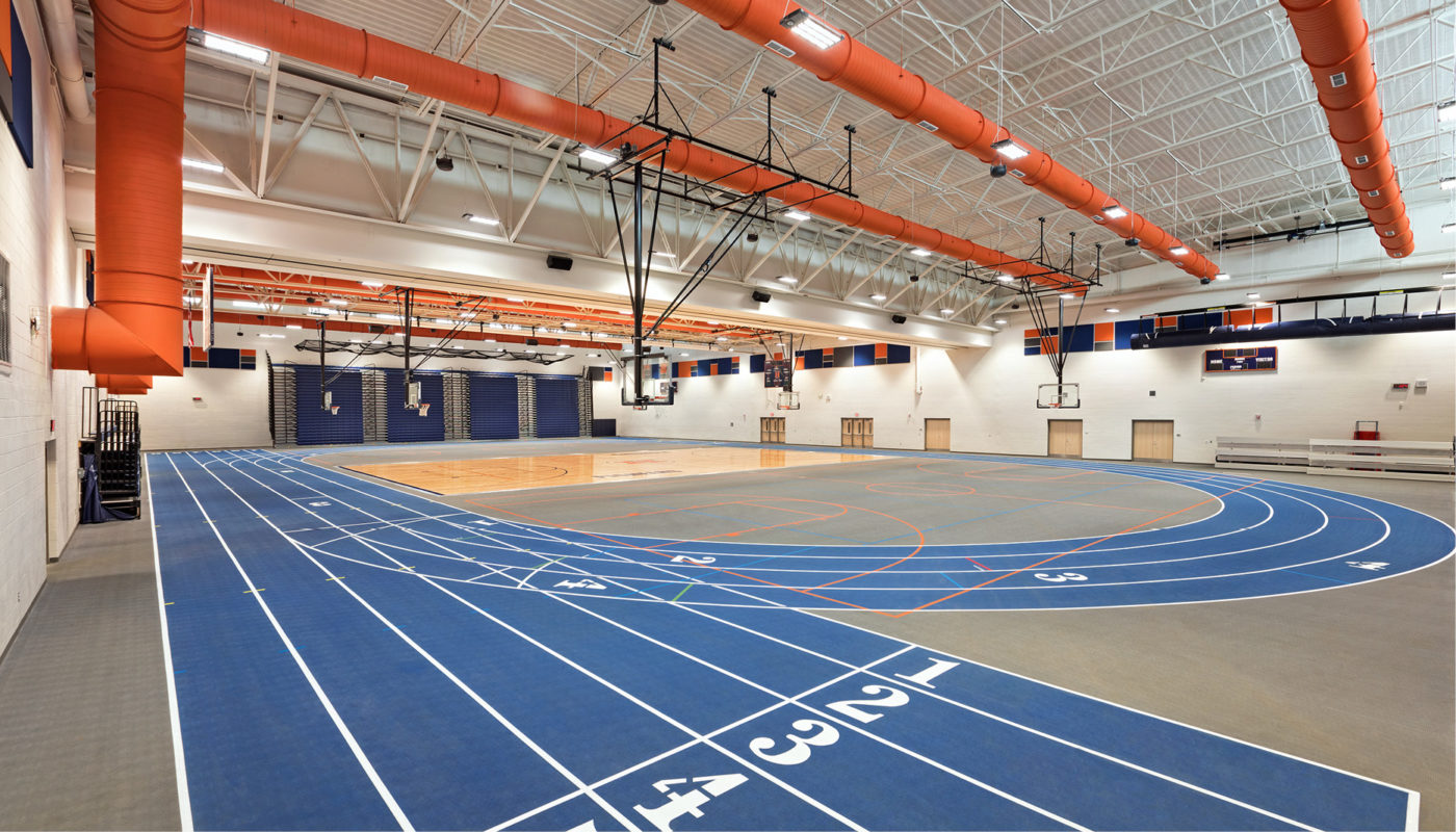 A gymnasium with a blue and orange track located at Heritage High School.