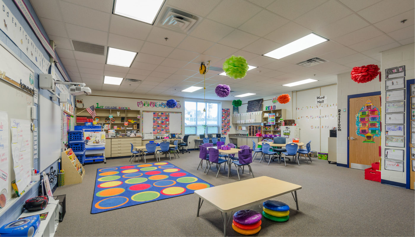 A classroom with colorful tables and chairs.