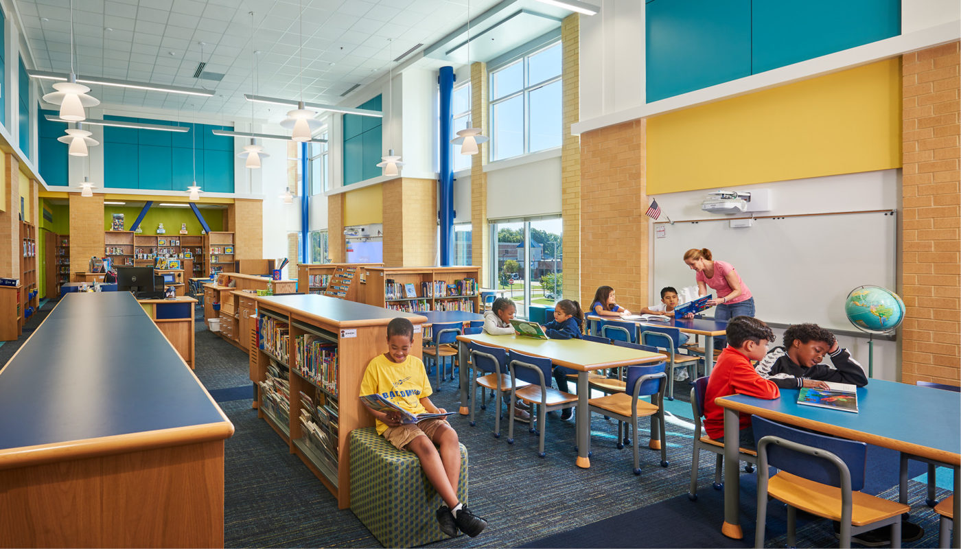 Students at Baldwin Elementary, an Intermediate School in the Manassas City Public Schools district, are sitting at desks in a school library.