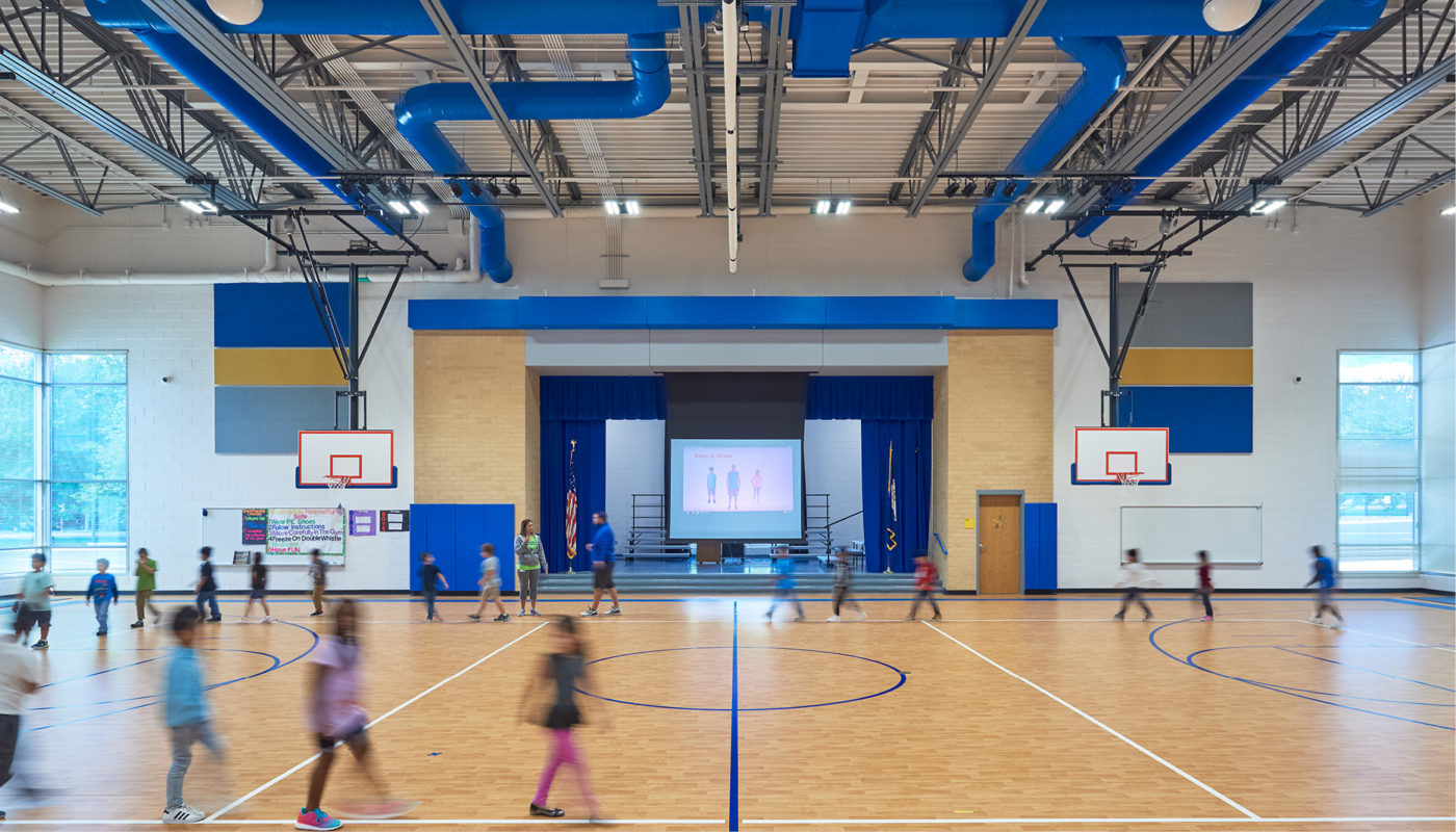 A basketball court with people playing on it at Baldwin Elementary, an Intermediate School in Manassas City Public Schools.