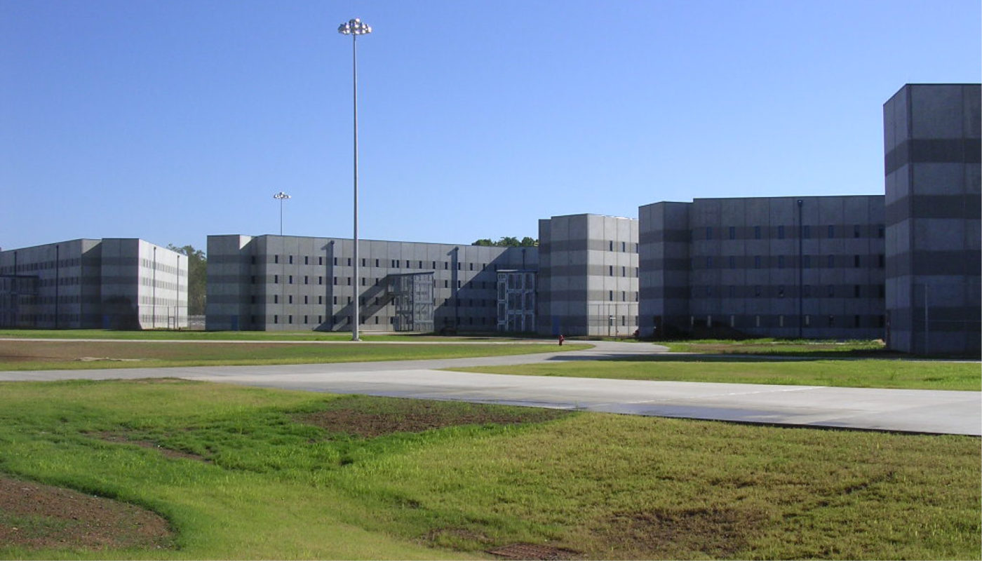 Butner Federal Correctional Institution with a grassy area in front of it.