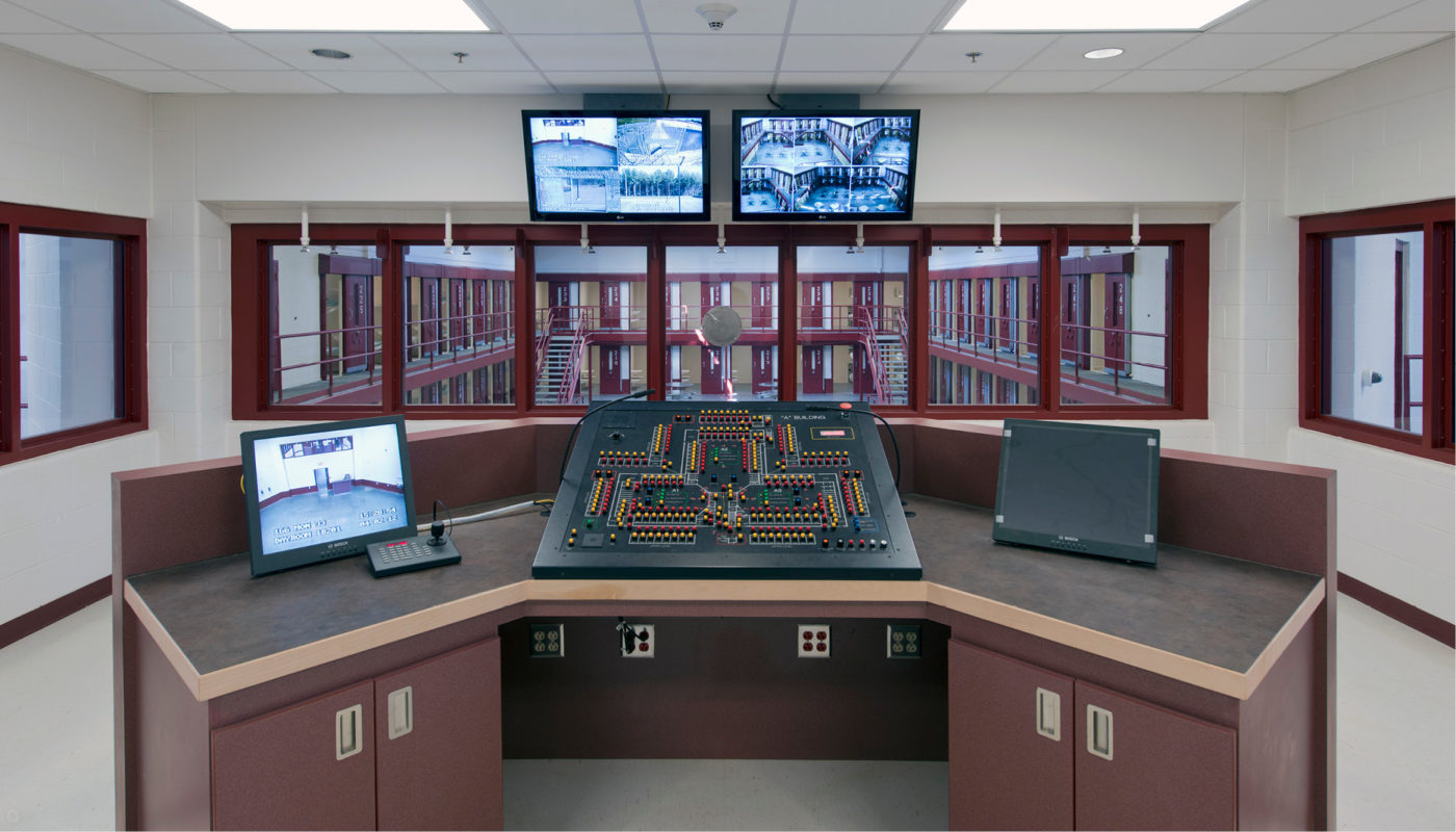A River North Correctional Institution control room with two monitors and a computer.