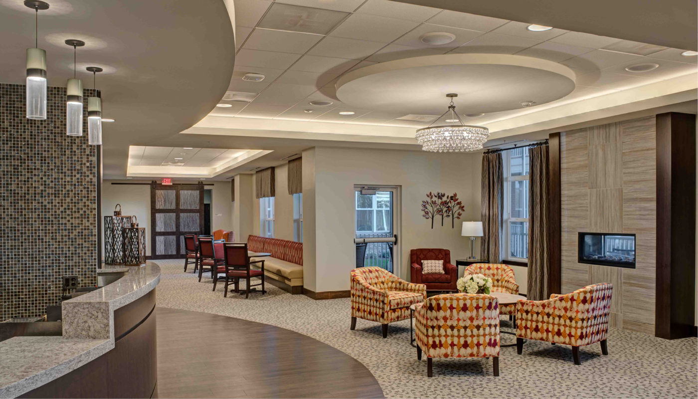 The lobby of a medical office is decorated with furniture and a chandelier at Ashby Ponds.