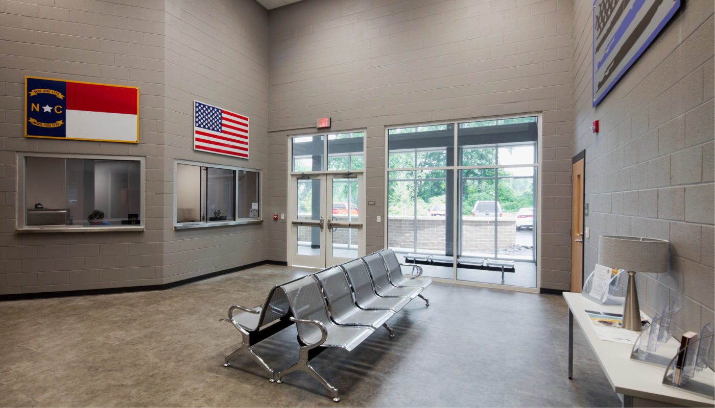 A waiting room at the Polk County Jail, adorned with flags hanging on the wall.
