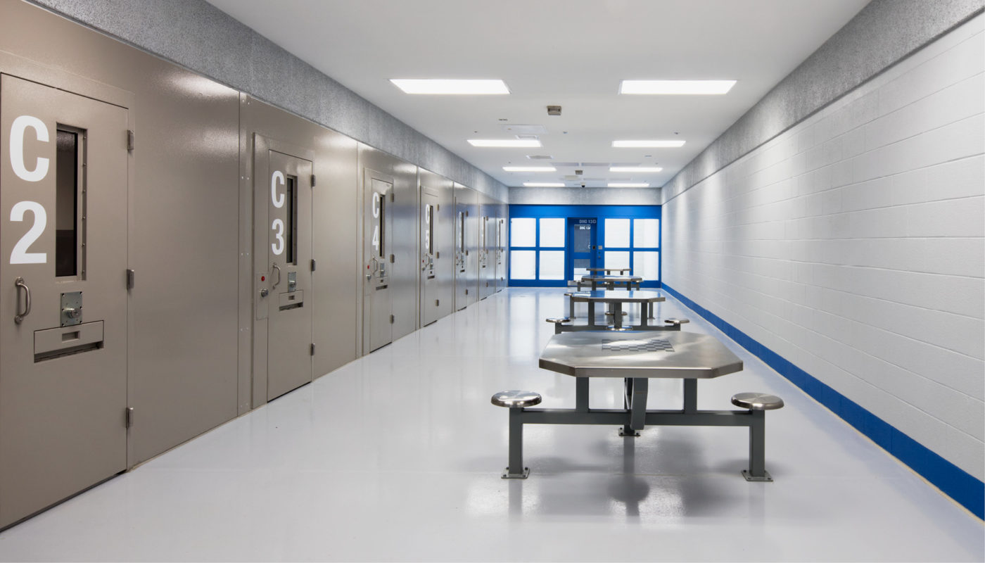 A Polk County hallway with benches and a blue wall, serving as a area for law enforcement activities.