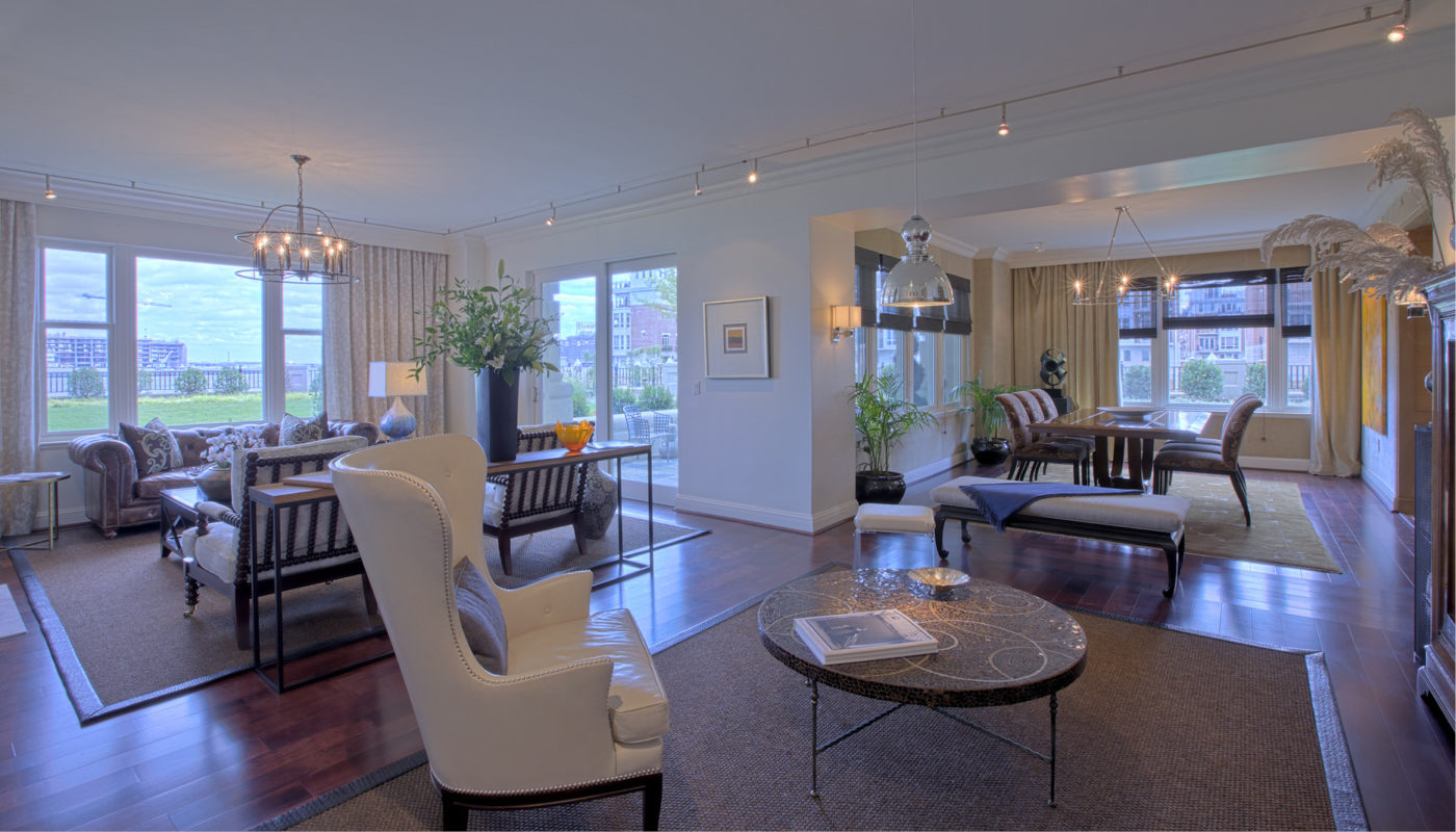 A Ritz-Carlton Residences living room with hardwood floors and a dining table.