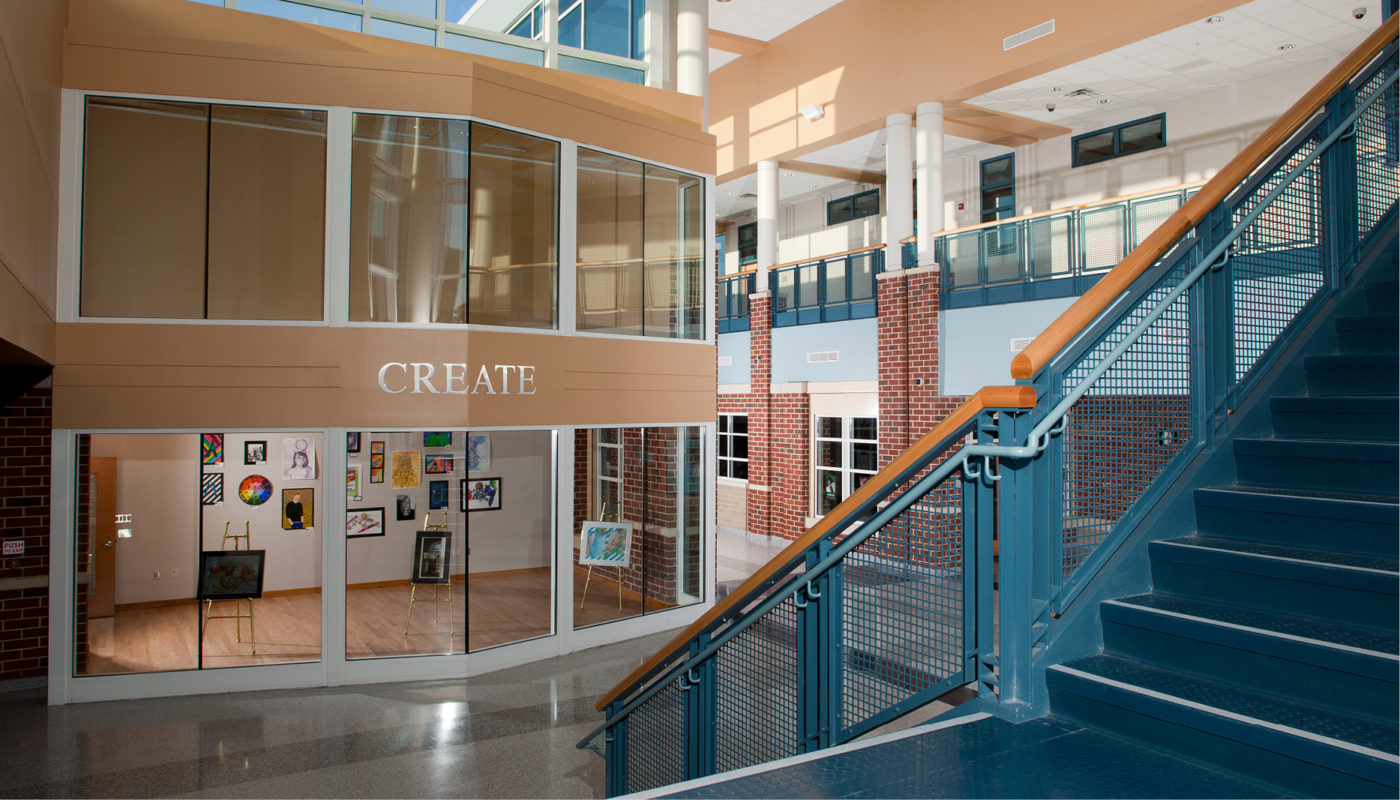 A staircase leading to a building with a glass wall in Glen Allen High School, part of Henrico County Public Schools.