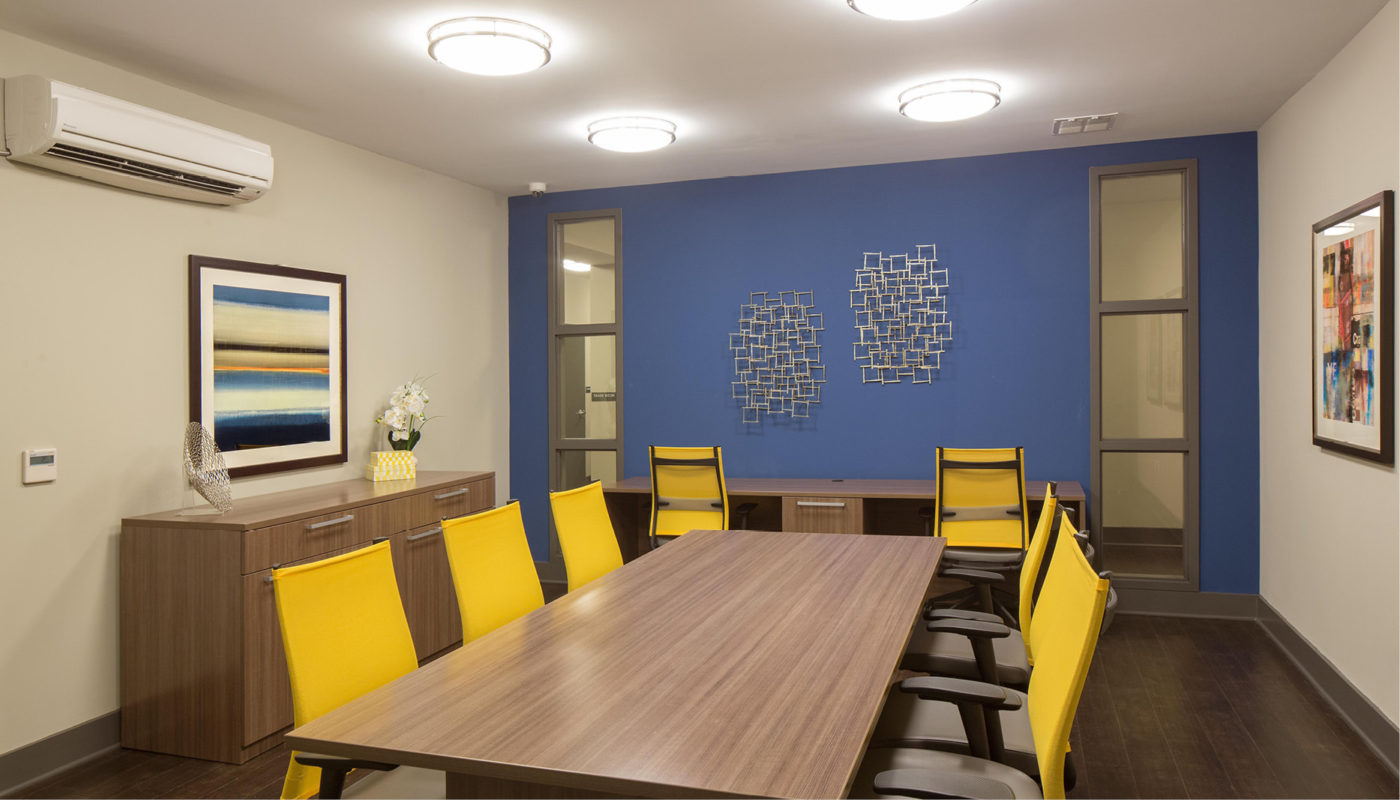 A conference room with mulberry chairs and blue walls in a park setting.