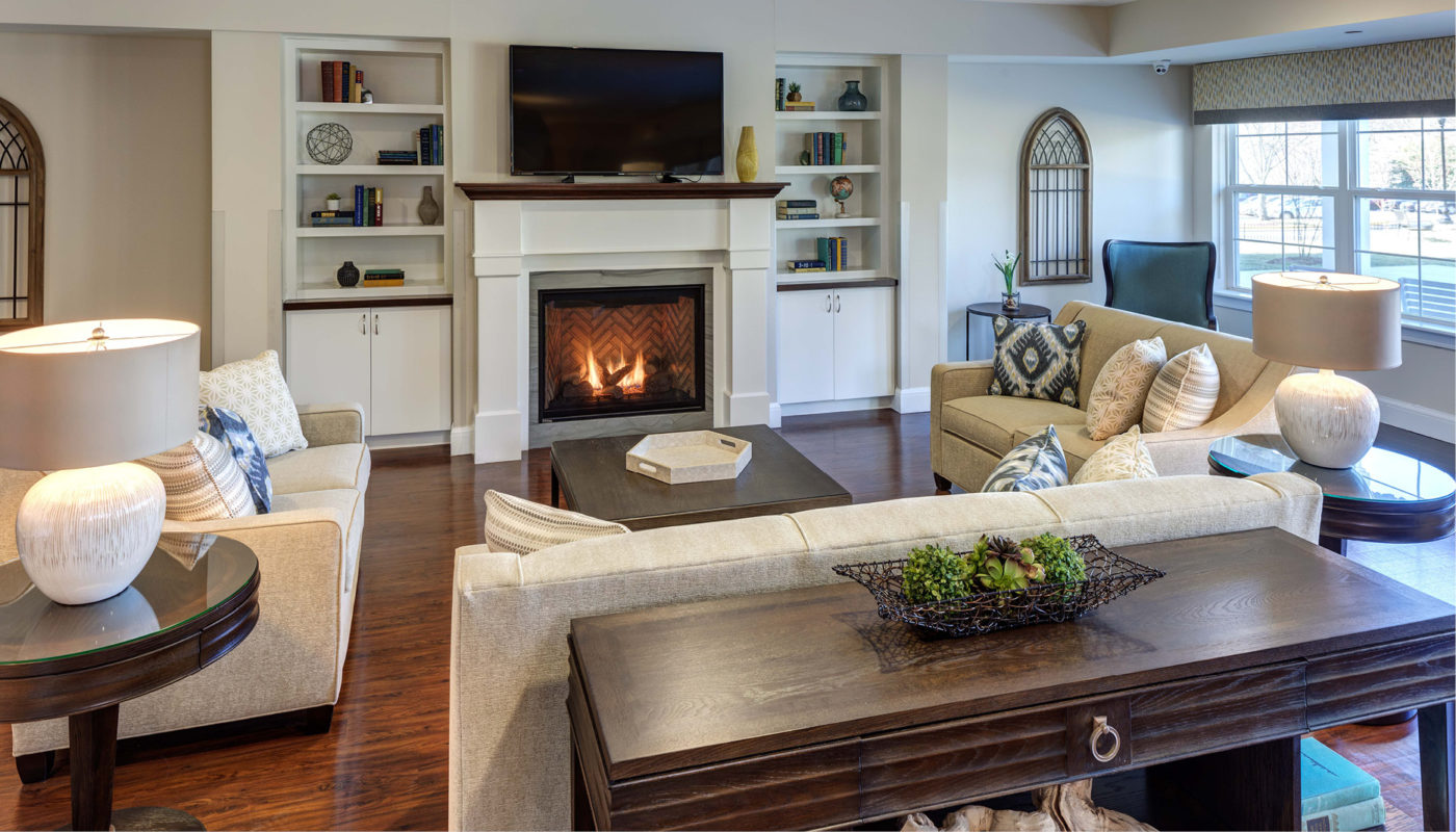 A living room in Oakcrest with couches and a fireplace.