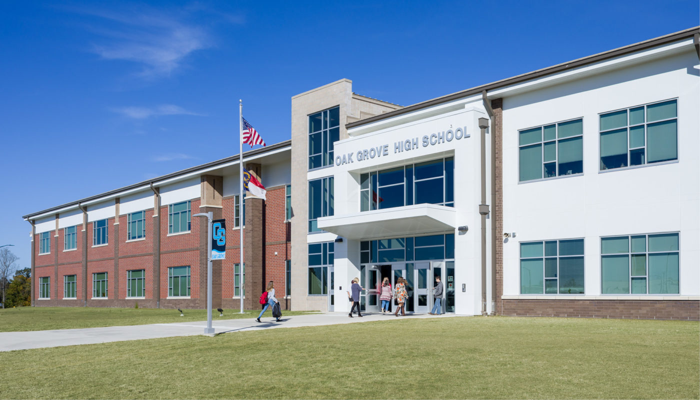 A school building with people walking in front of it, belonging to Davidson County Schools.
