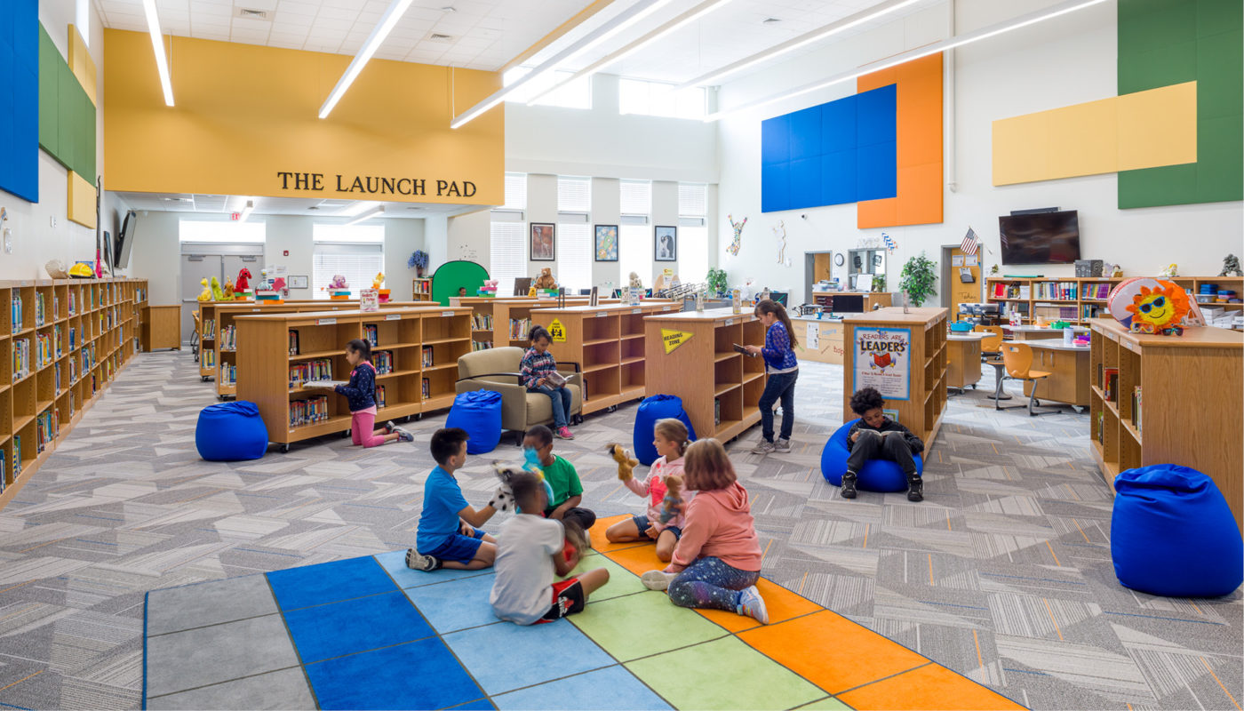 A school library at Royal Oaks Elementary School with children sitting on the floor.