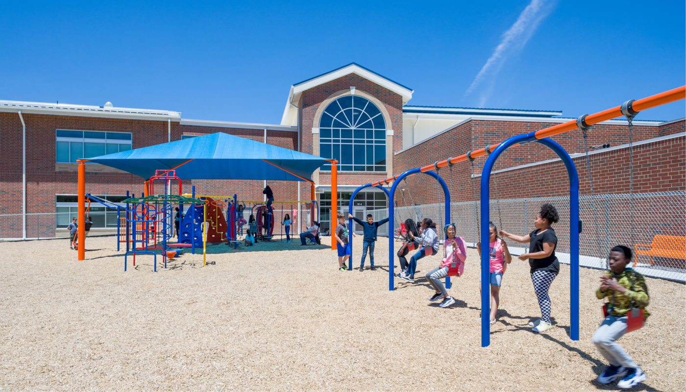 A group of children from Royal Oaks Elementary playing on a playground in Cabarrus County Schools.