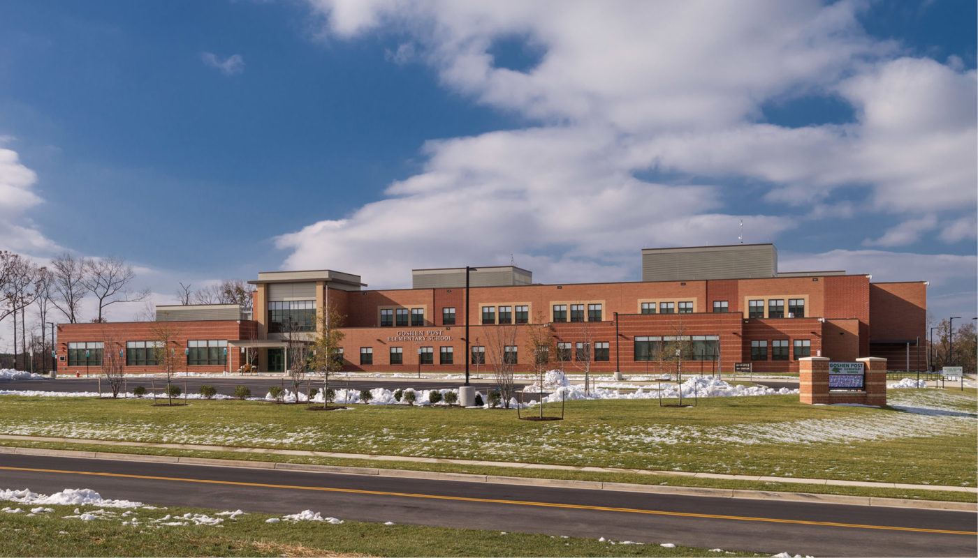 Goshen Post Elementary School, a large brick building with snow on the ground, is part of Loudoun County Public Schools.