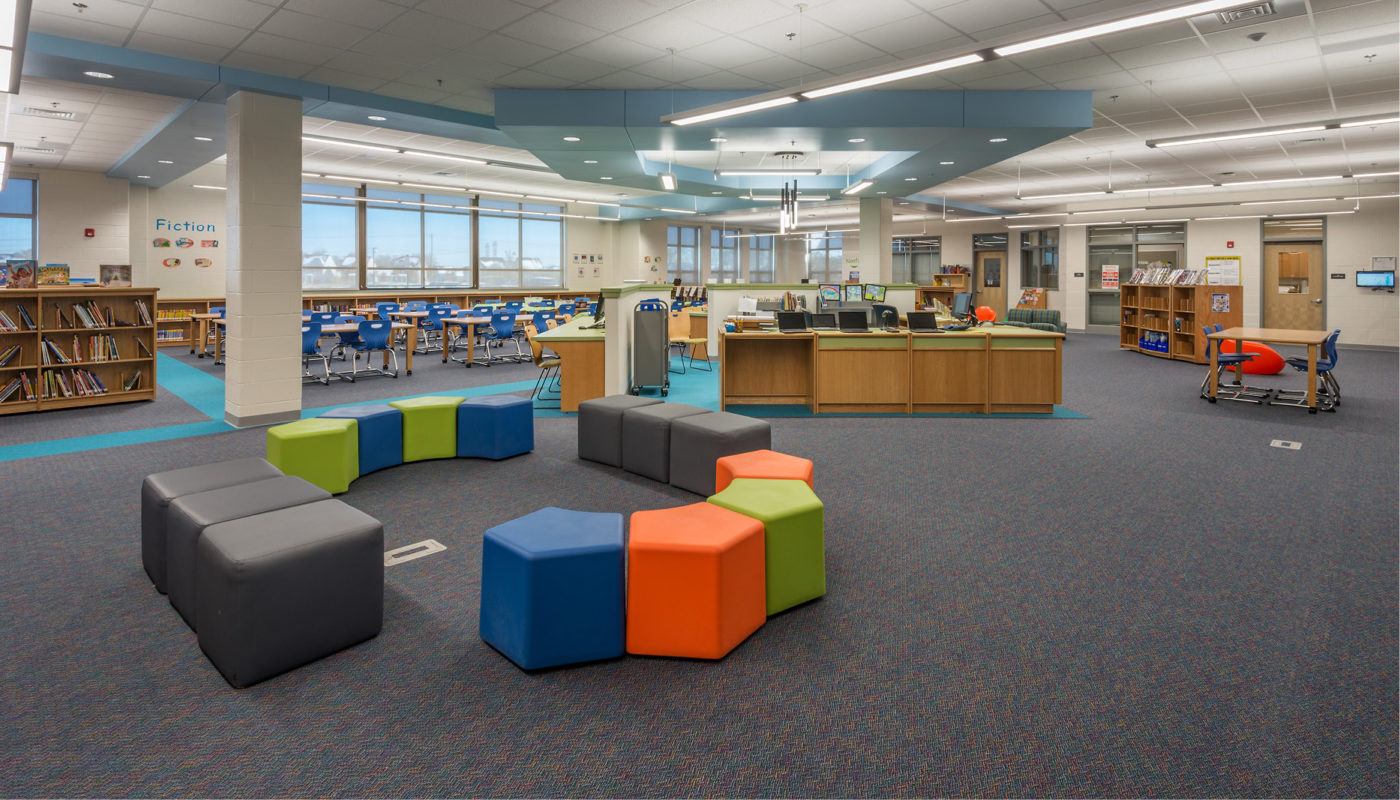Goshen Post Elementary School library with a colorful seating area.