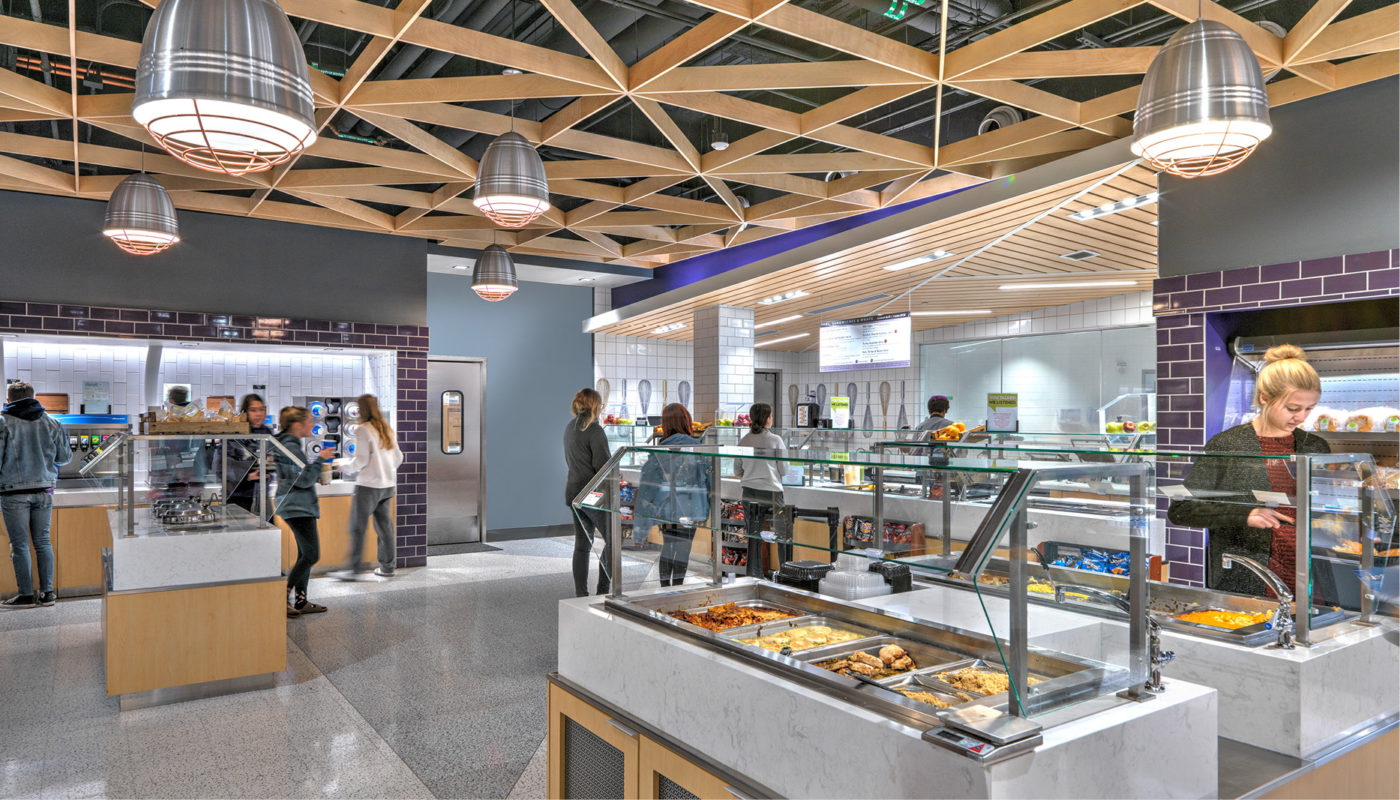 A rendering of D Hall, the cafeteria at James Madison University, with people standing around.