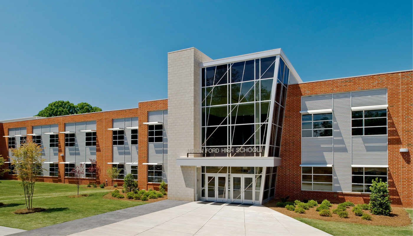 The exterior of Nation Ford High School, a brick building with glass windows.