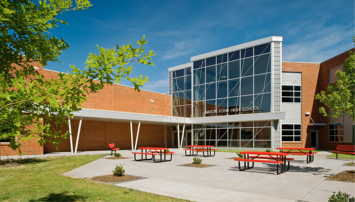 A brick building with red benches located in the Fort Mill School District.