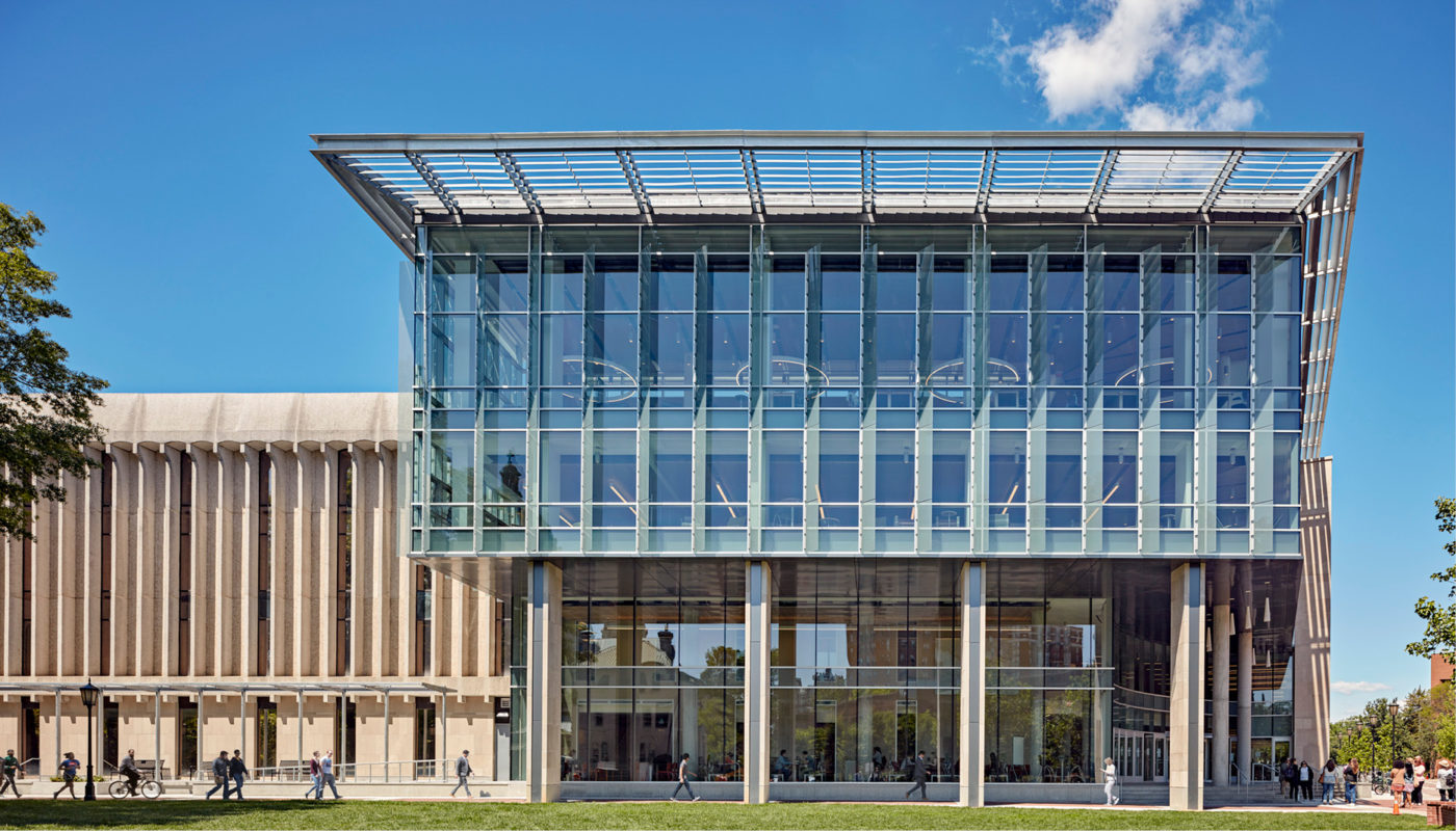 The James Branch Cabell Library, located at Virginia Commonwealth University, is a large glass building with a grassy field in the background.