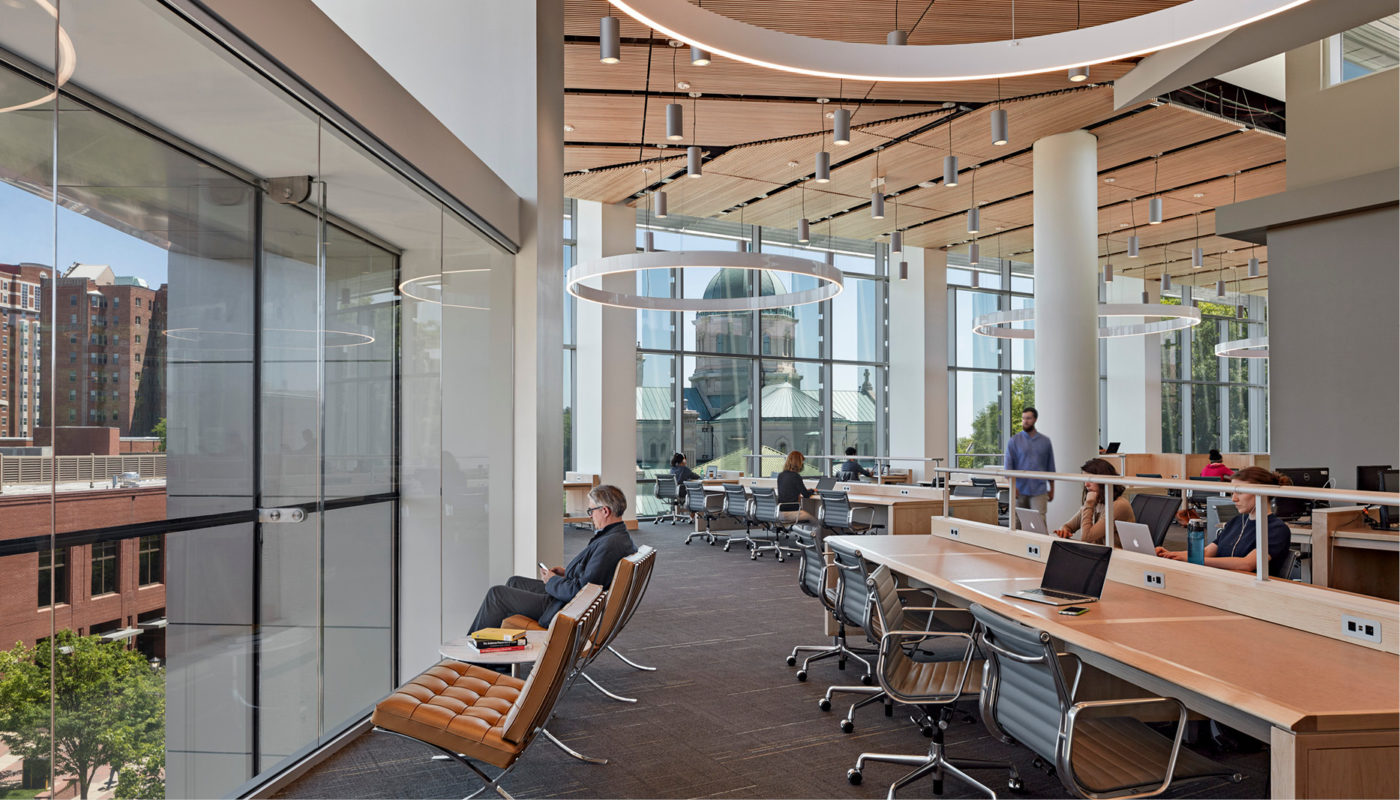 A large open space with people sitting at desks inside the James Branch Cabell Library at Virginia Commonwealth University.